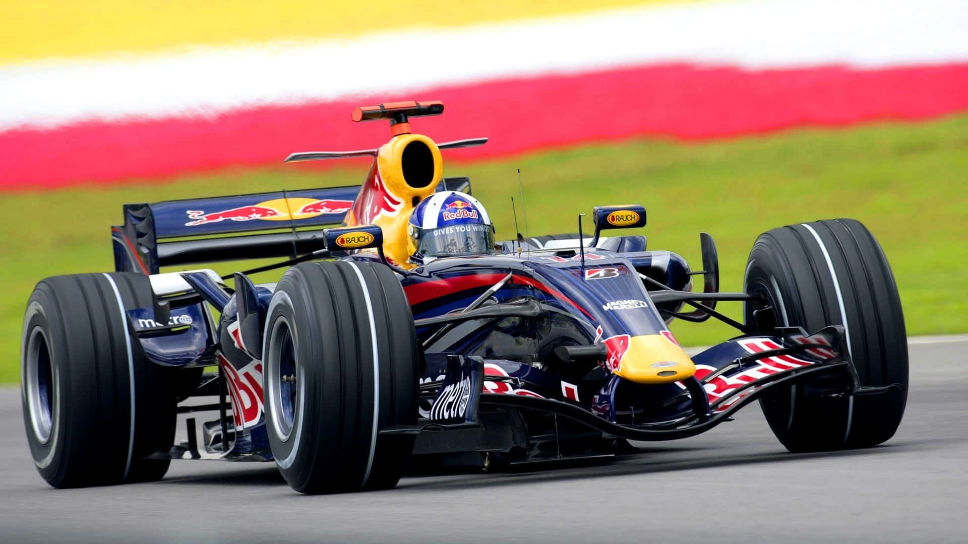 A Red Bull Racing Car Driving On A Track