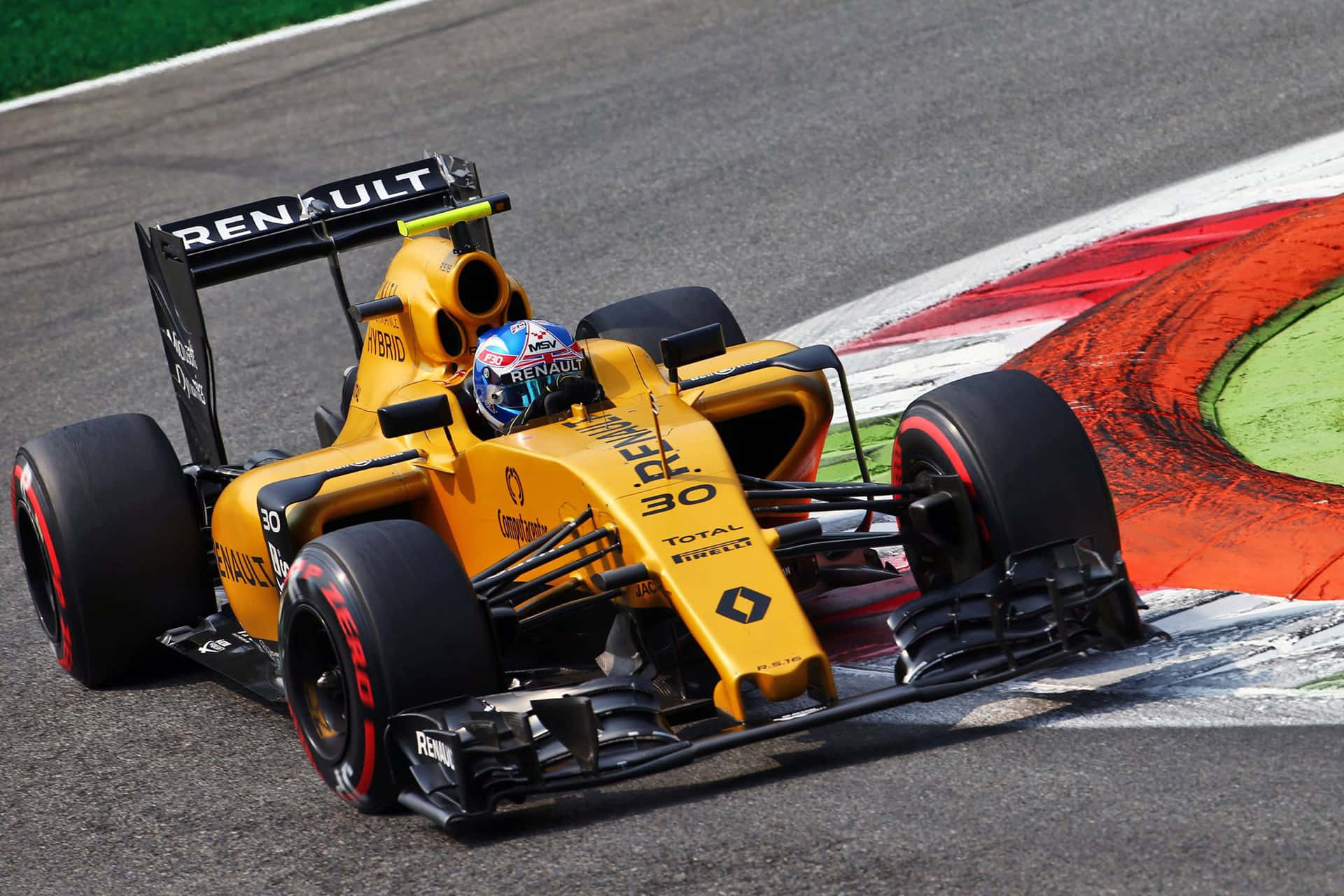 A Yellow Racing Car Driving Around A Track