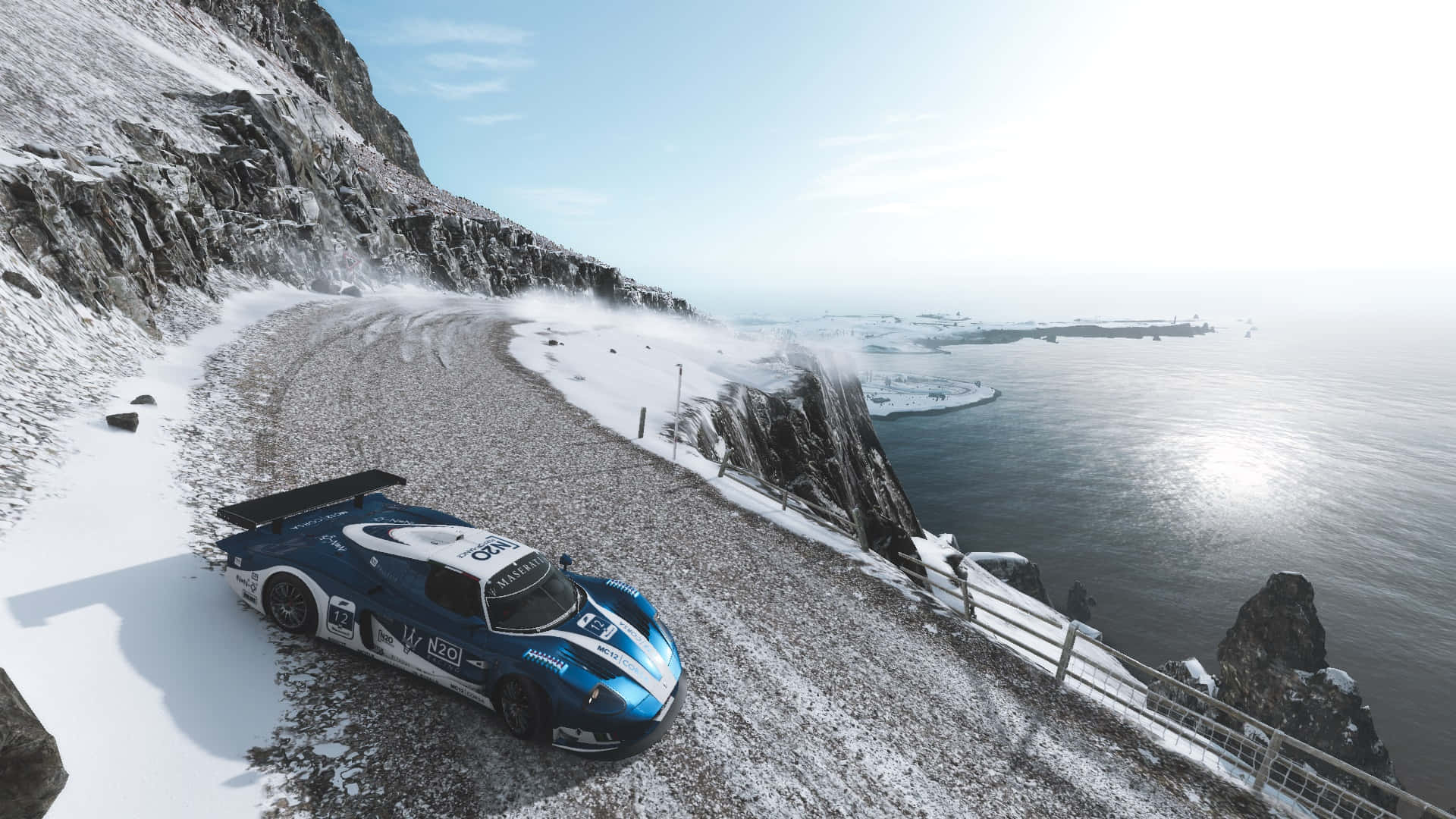A Blue Race Car Driving Down A Snowy Mountain