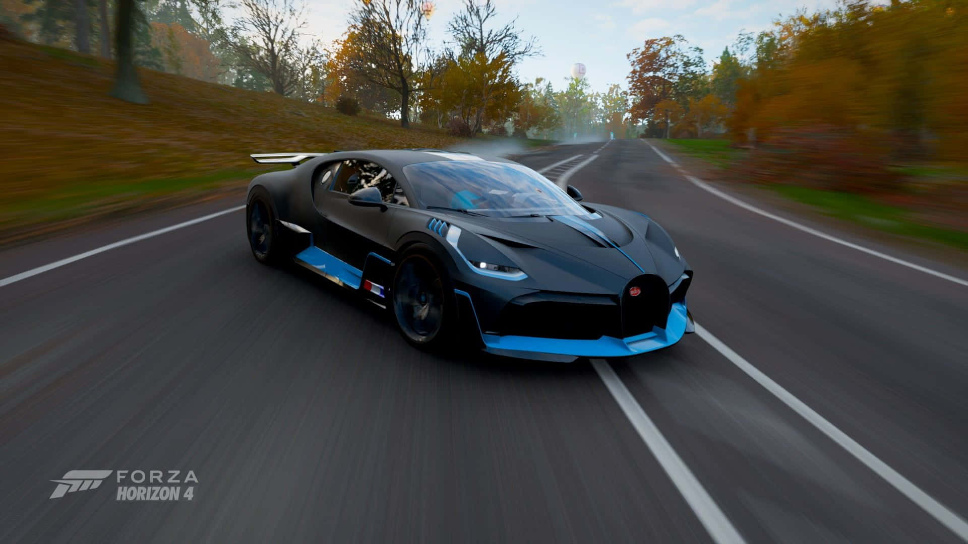 A Blue And Black Car Driving Down A Road