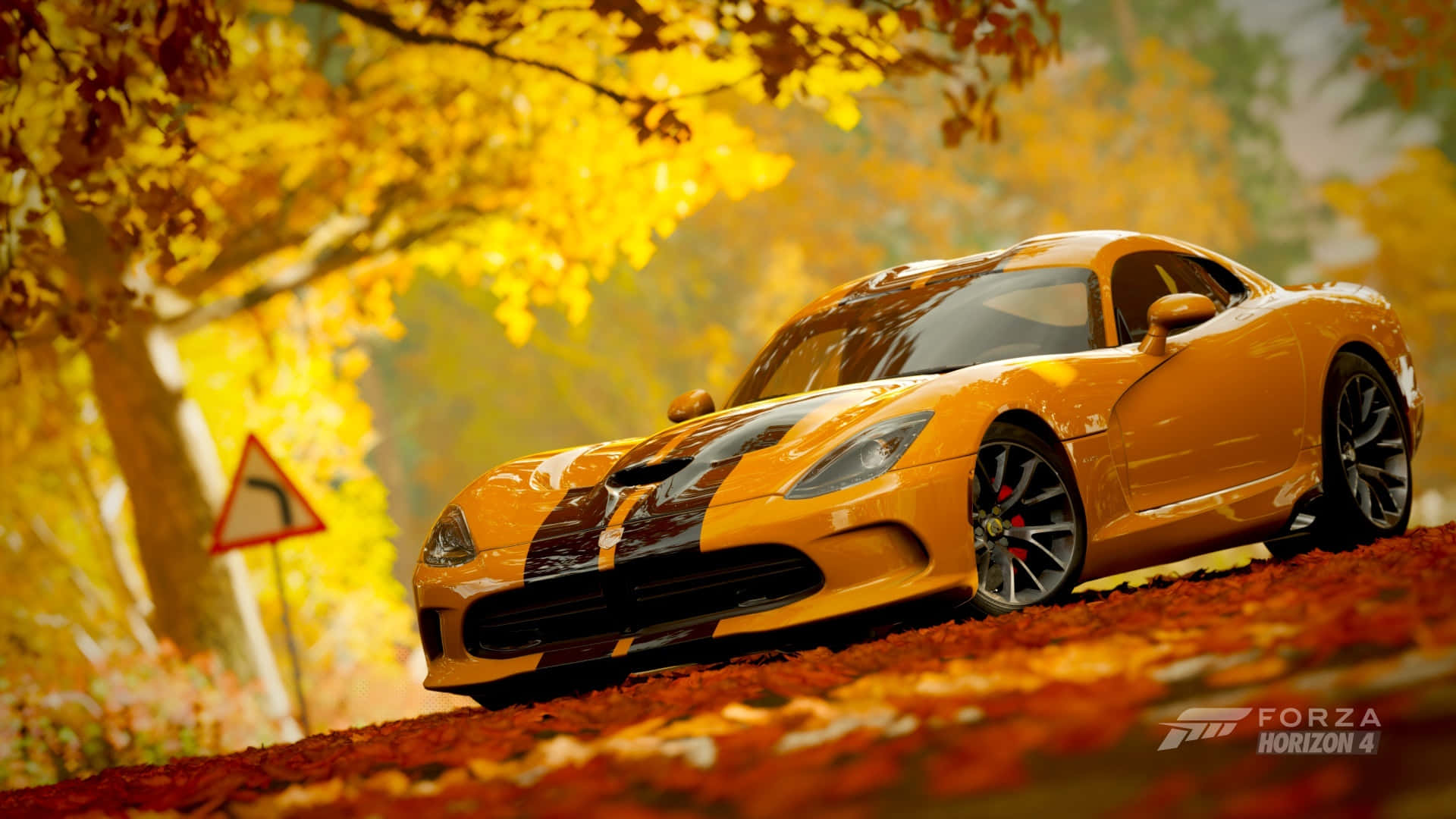 A Yellow Sports Car Driving Down A Road In Autumn