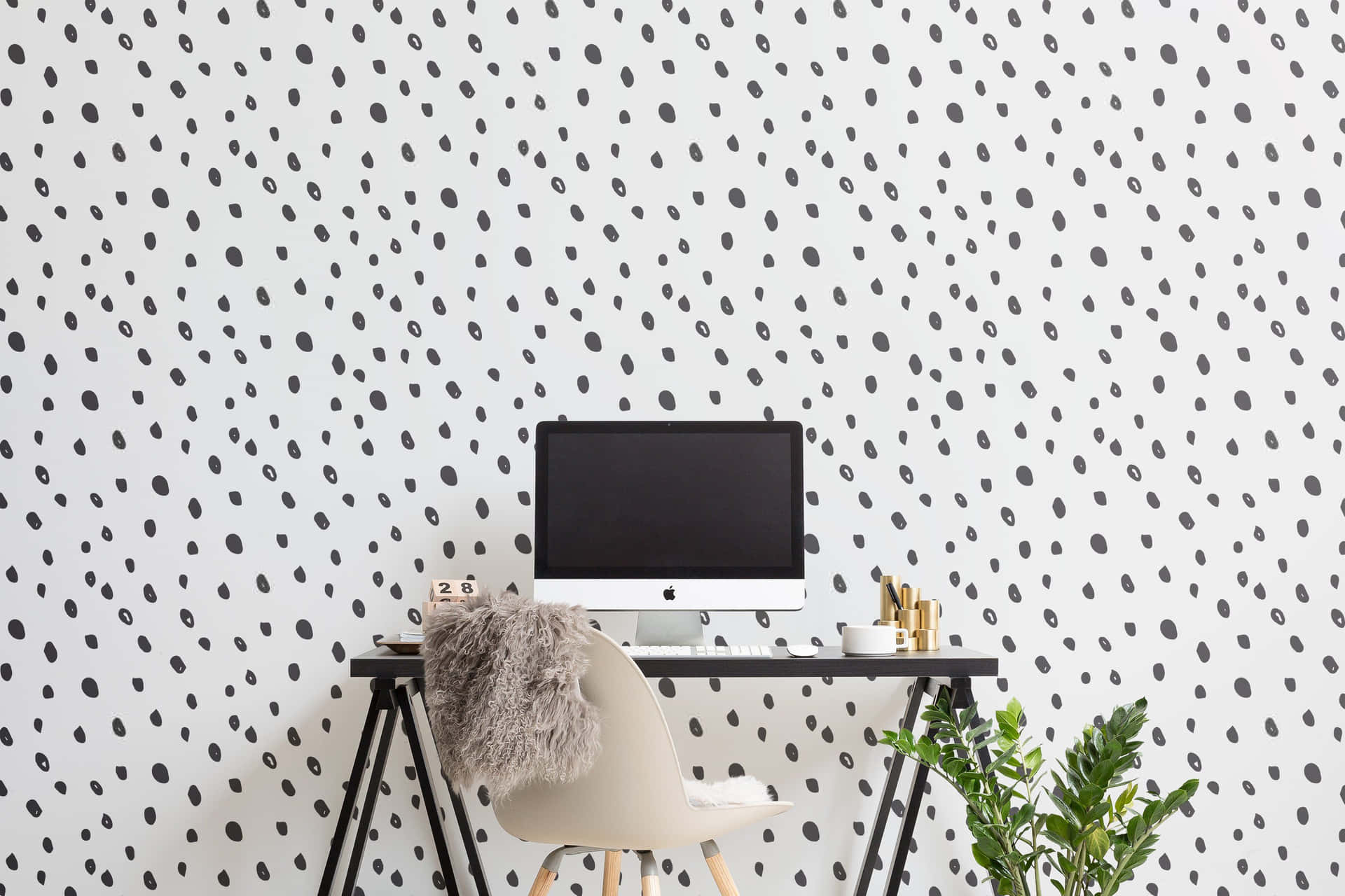 A Desk With A Black And White Polka Dot Wallpaper