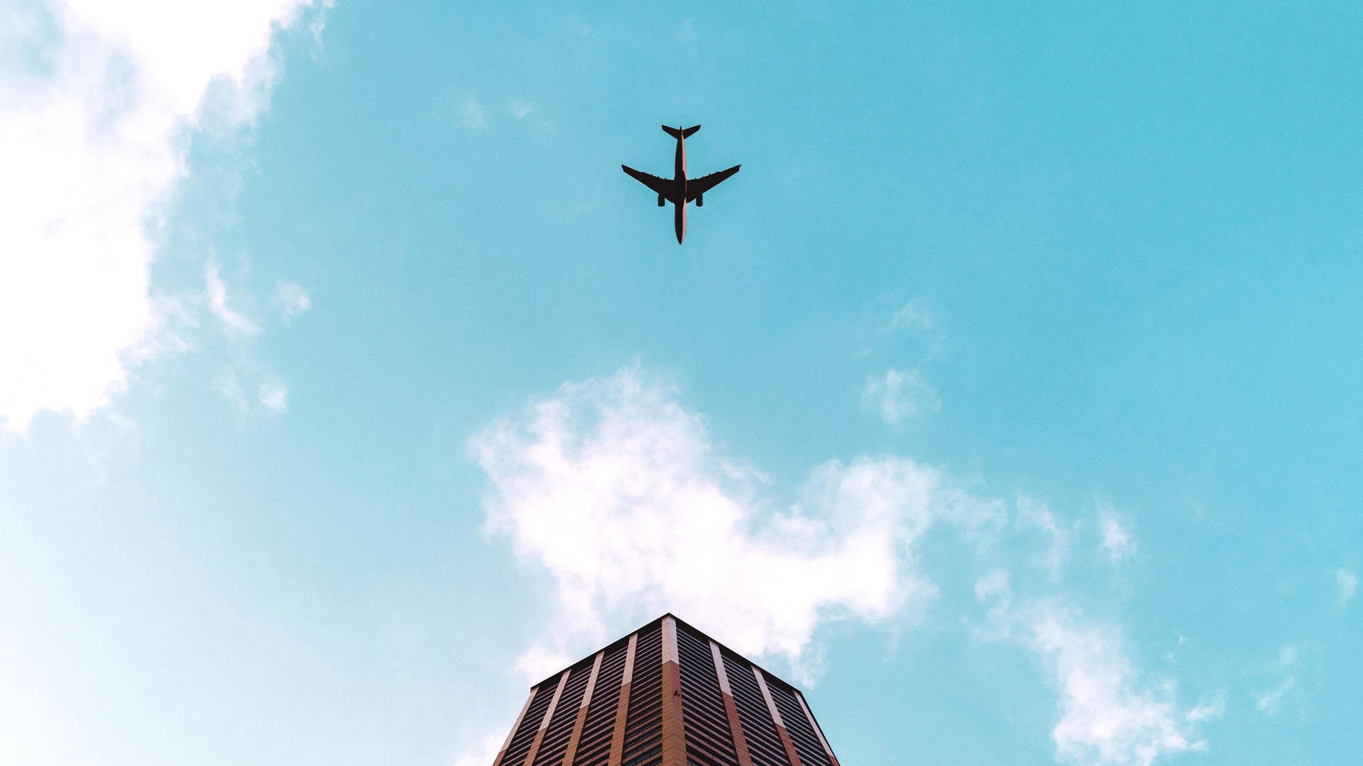 Hd Plane Flying Over Building