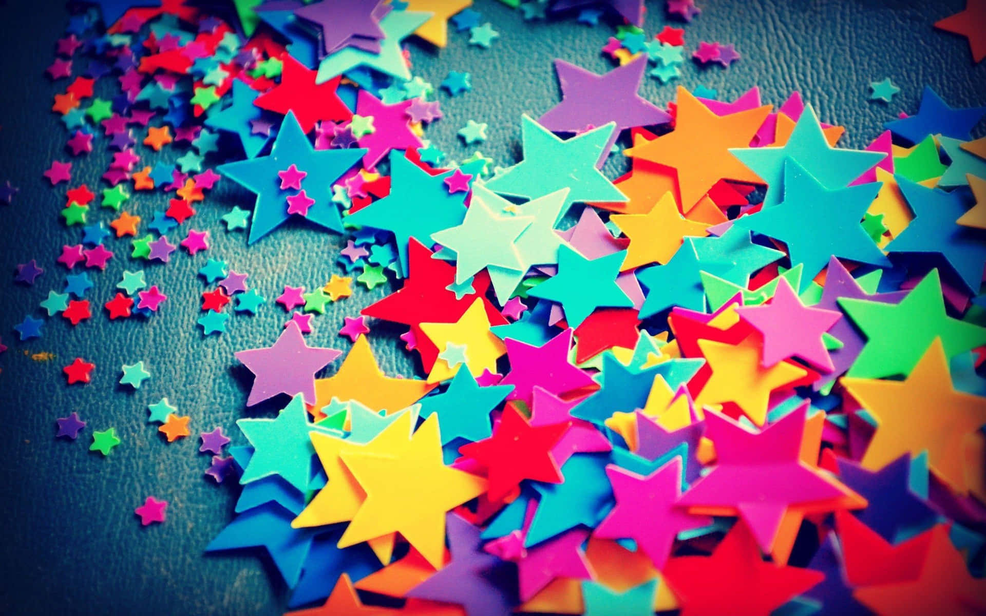 Colorful Stars On A Dark Surface Wallpaper