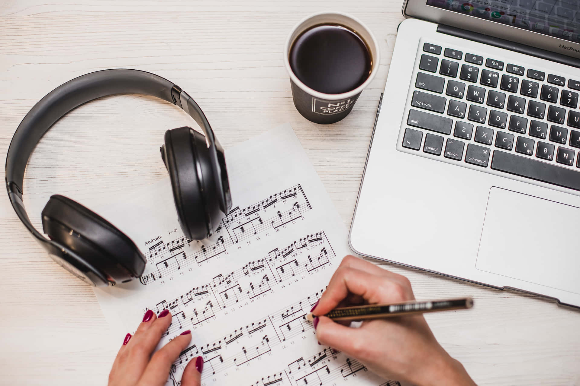 A laptop and headphones creating musical harmony Wallpaper