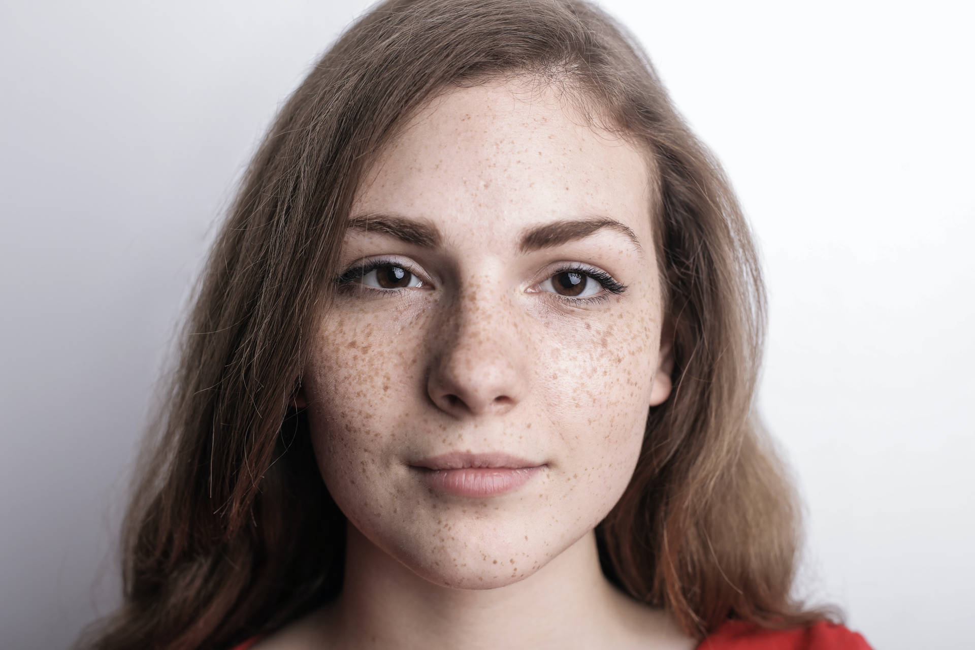 Headshot Of A Girl With Freckles On Face Wallpaper