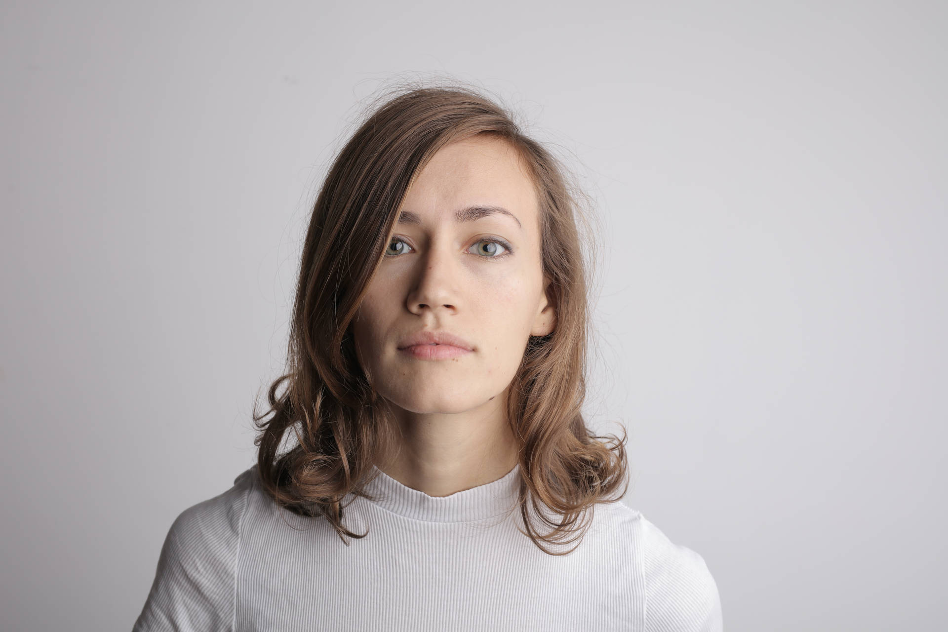 Headshot Of A Woman In Plain Wallpaper