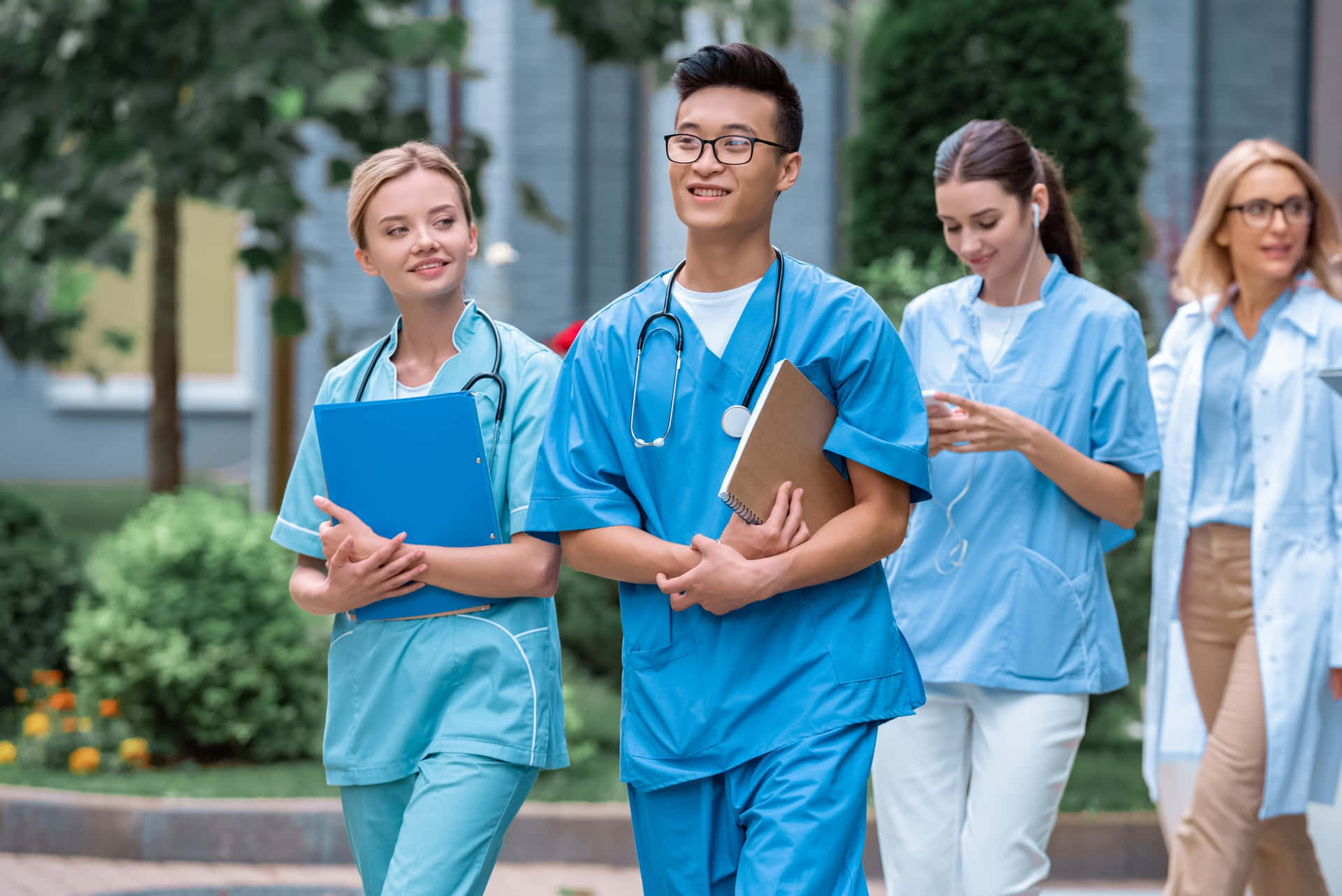 A Group Of Nurses Walking Down The Street