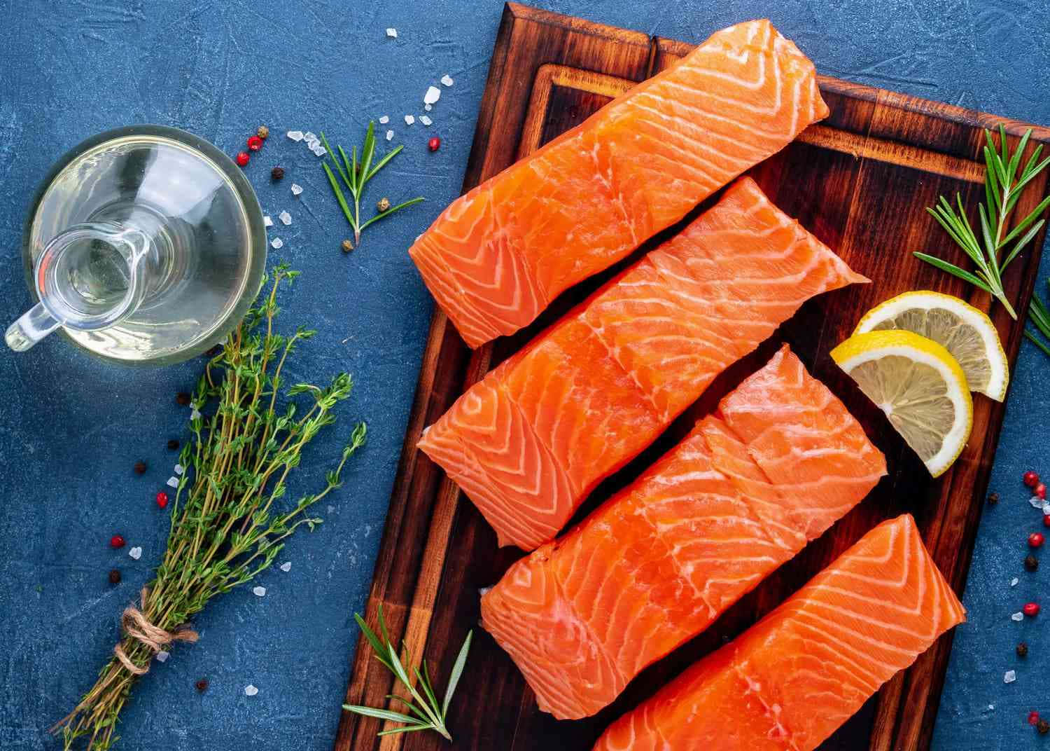 Salmon On A Cutting Board With Lemon And Rosemary
