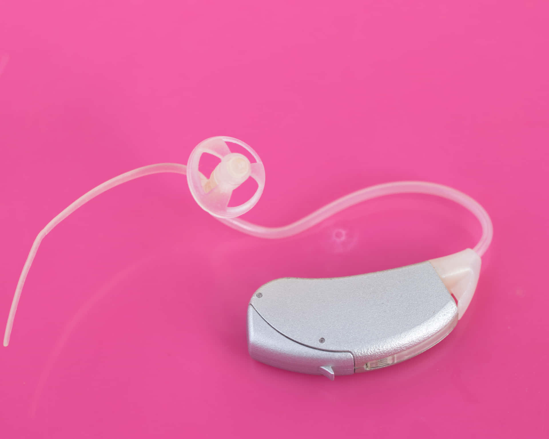 Hearing Aid On Pink Wallpaper
