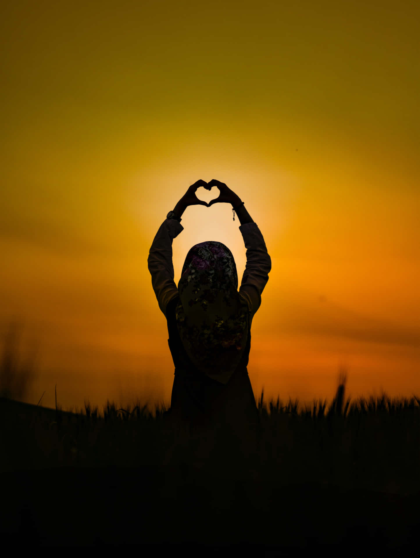 Download Heart Silhouette Against a Stunning Sunset Wallpaper