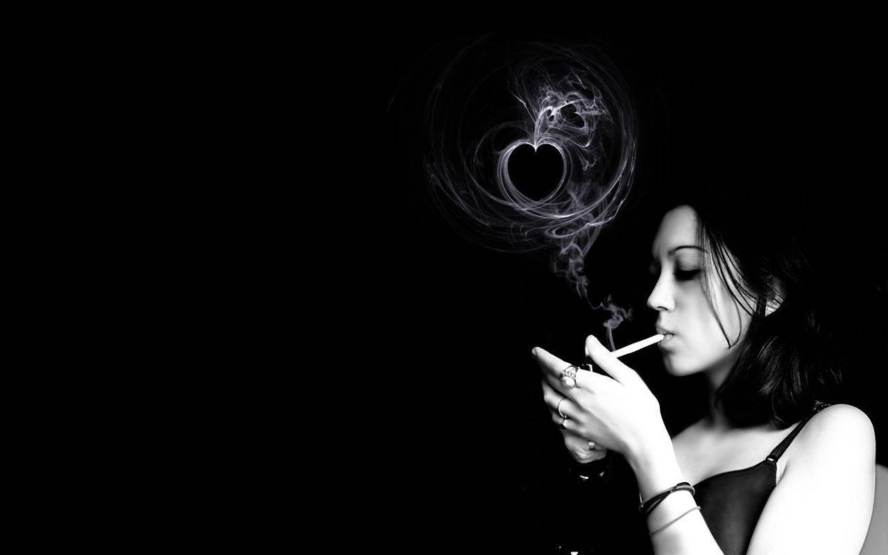 A Woman Breathing Out Heart-Shaped Smoke Wallpaper