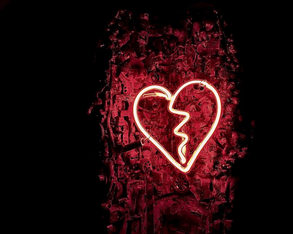 a broken heart neon sign on a black background