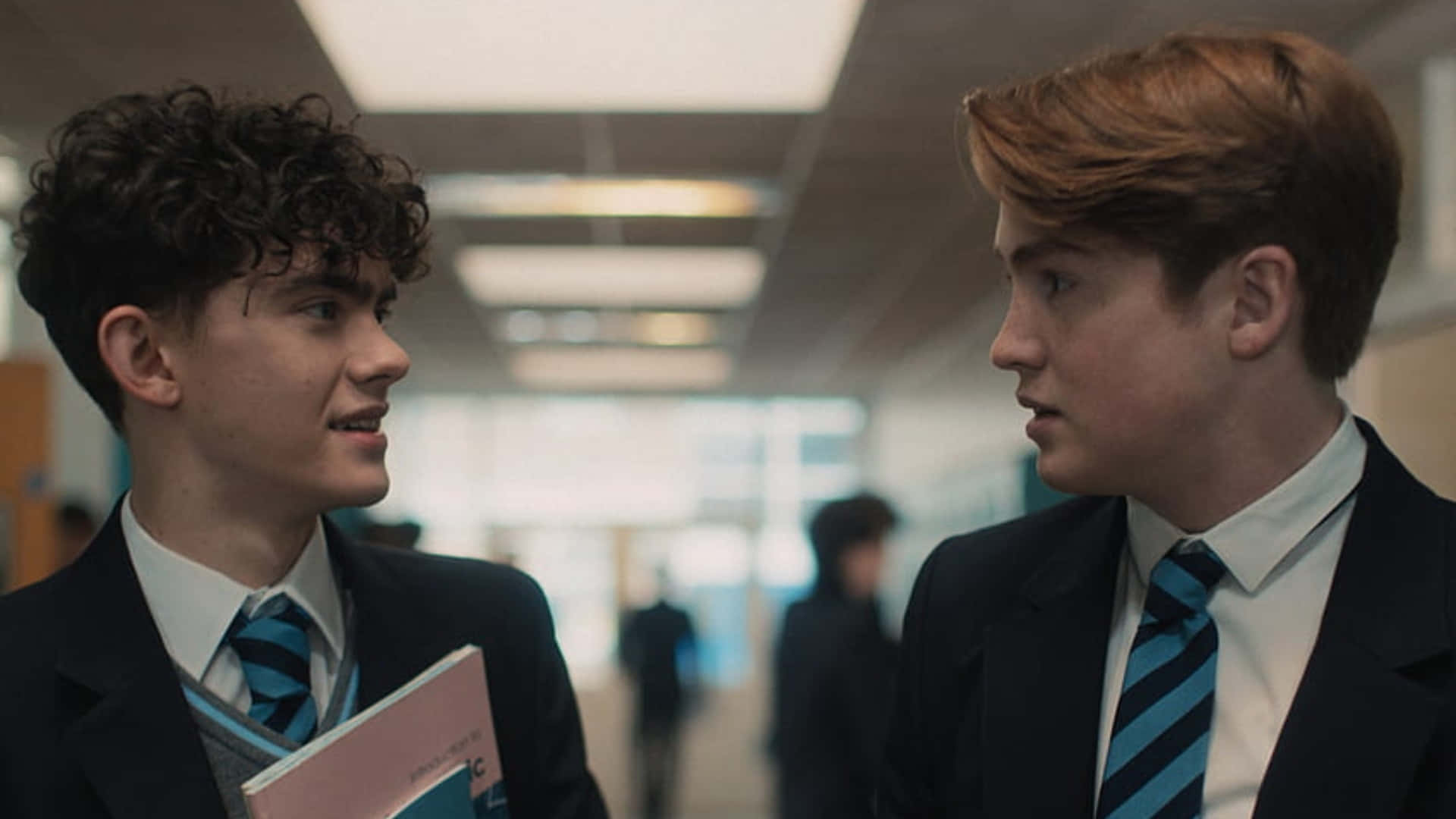 Two Boys In School Uniforms Talking To Each Other