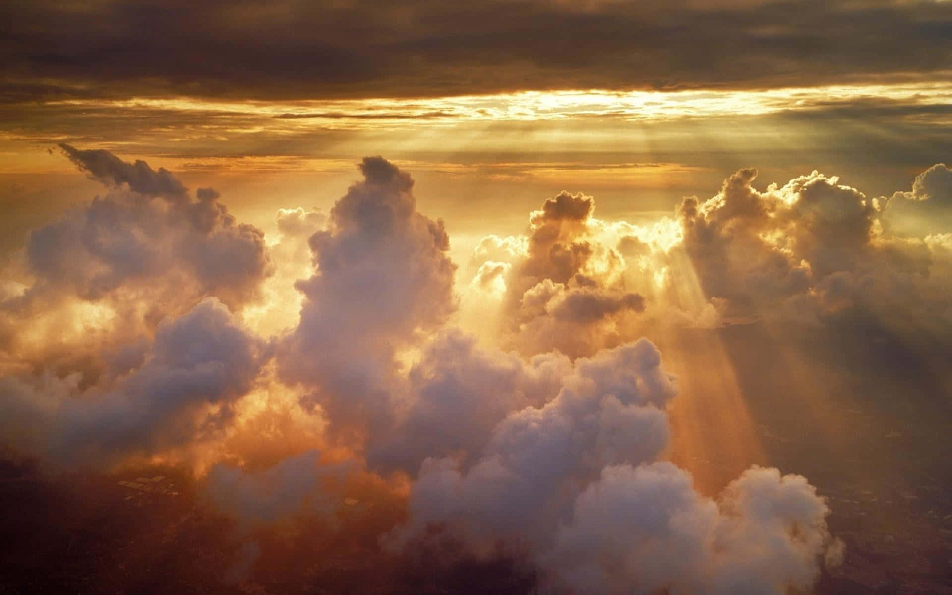 A breathtaking view of a deep blue sky with towering clouds and bright sunshine