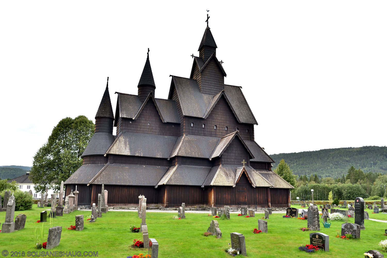 Heddal Stave Church Graveyard With Roses Wallpaper