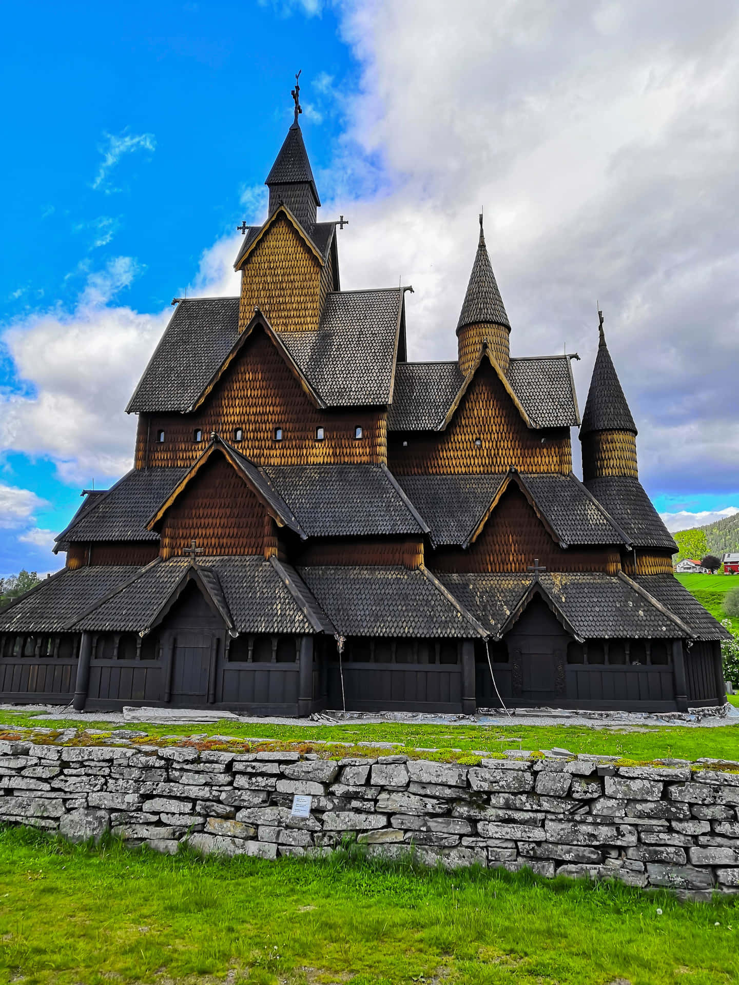 Heddal Stave Church Under Cloudy Sky Wallpaper
