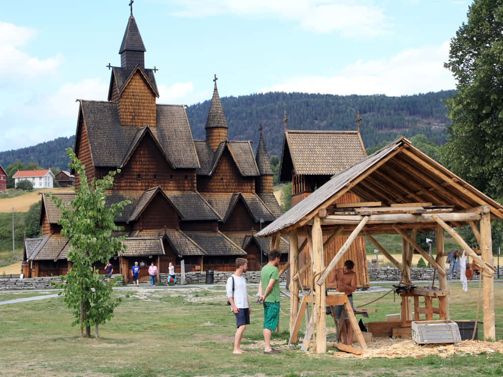 Tourists exploring the majestic Heddal Stave Church Wallpaper