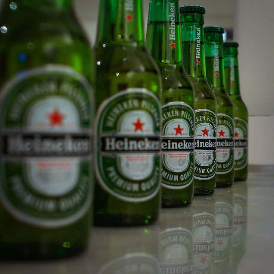 Chilled Heineken beer bottle with logo on dark background