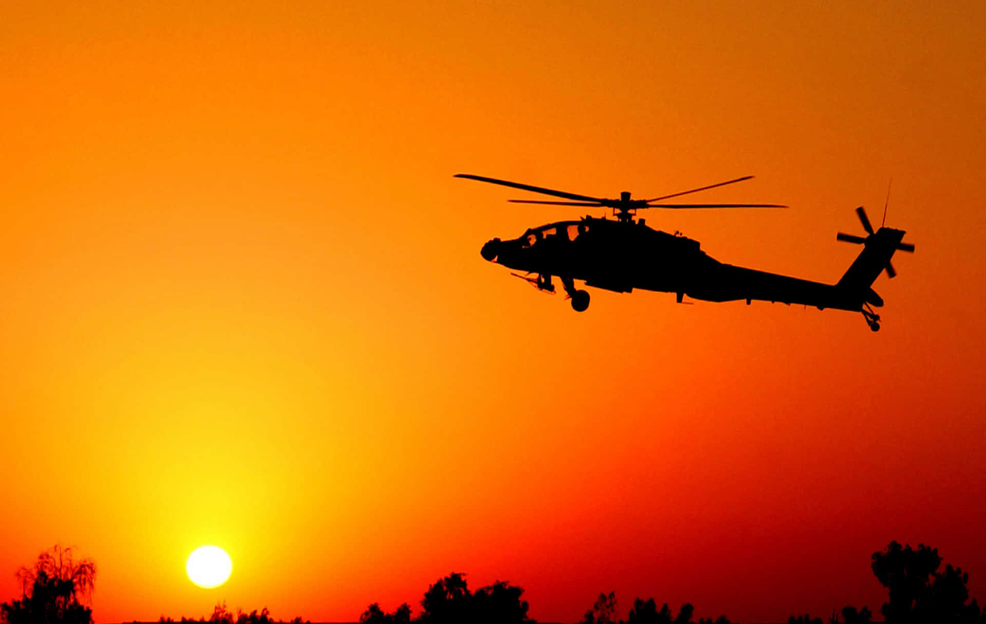 A helicopter takes flight in a sunset sky