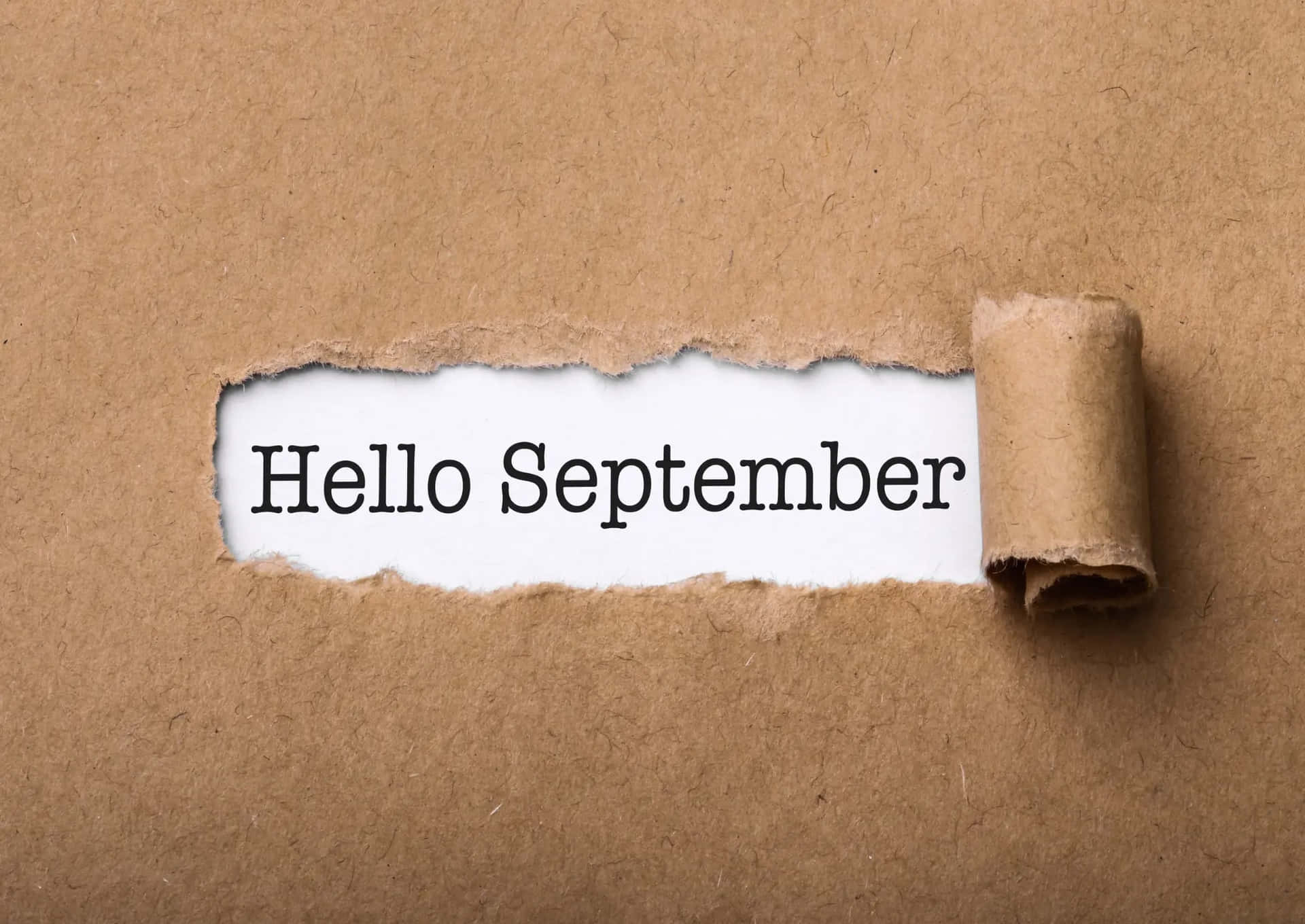 Hello September Revealed Through Torn Paper Wallpaper