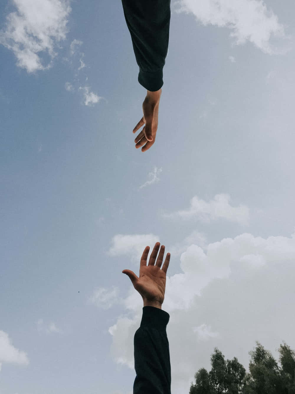 Two People Reaching For The Sky