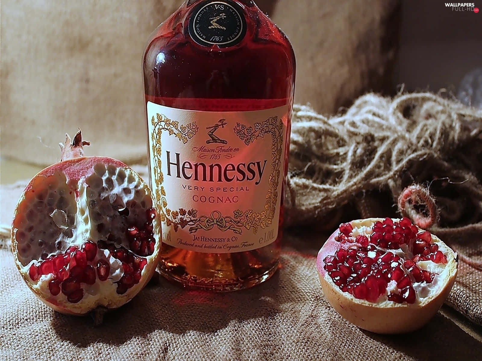 A Bottle Of Hennessy Rum With A Pomegranate Wallpaper
