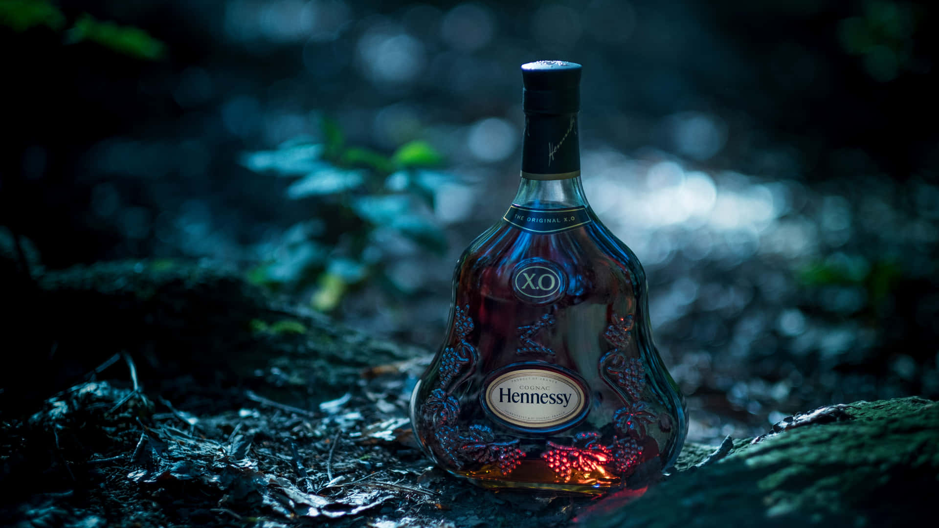 A Bottle Of Liqueur Sitting On The Ground Wallpaper