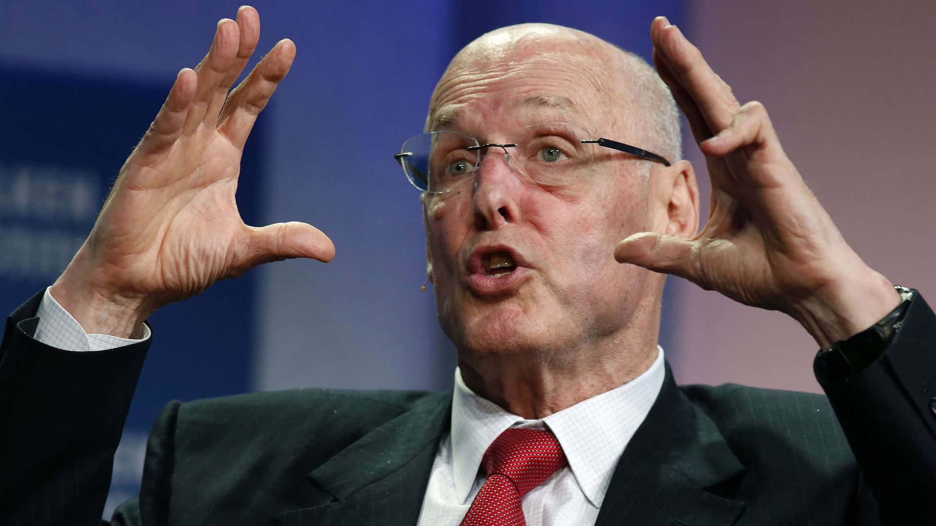 Henry Paulson Animatedly Gesturing During a Speech Wallpaper