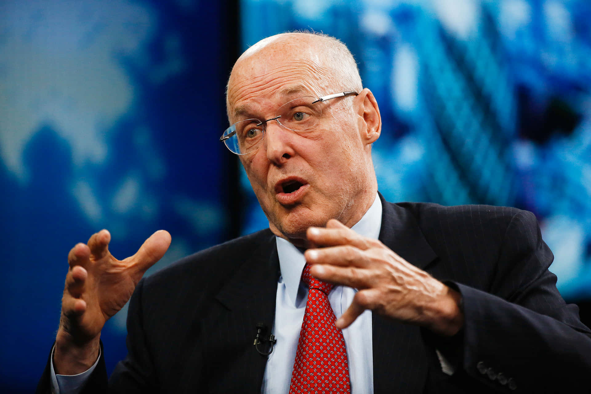 Henry Paulson delivering speech on a show Wallpaper