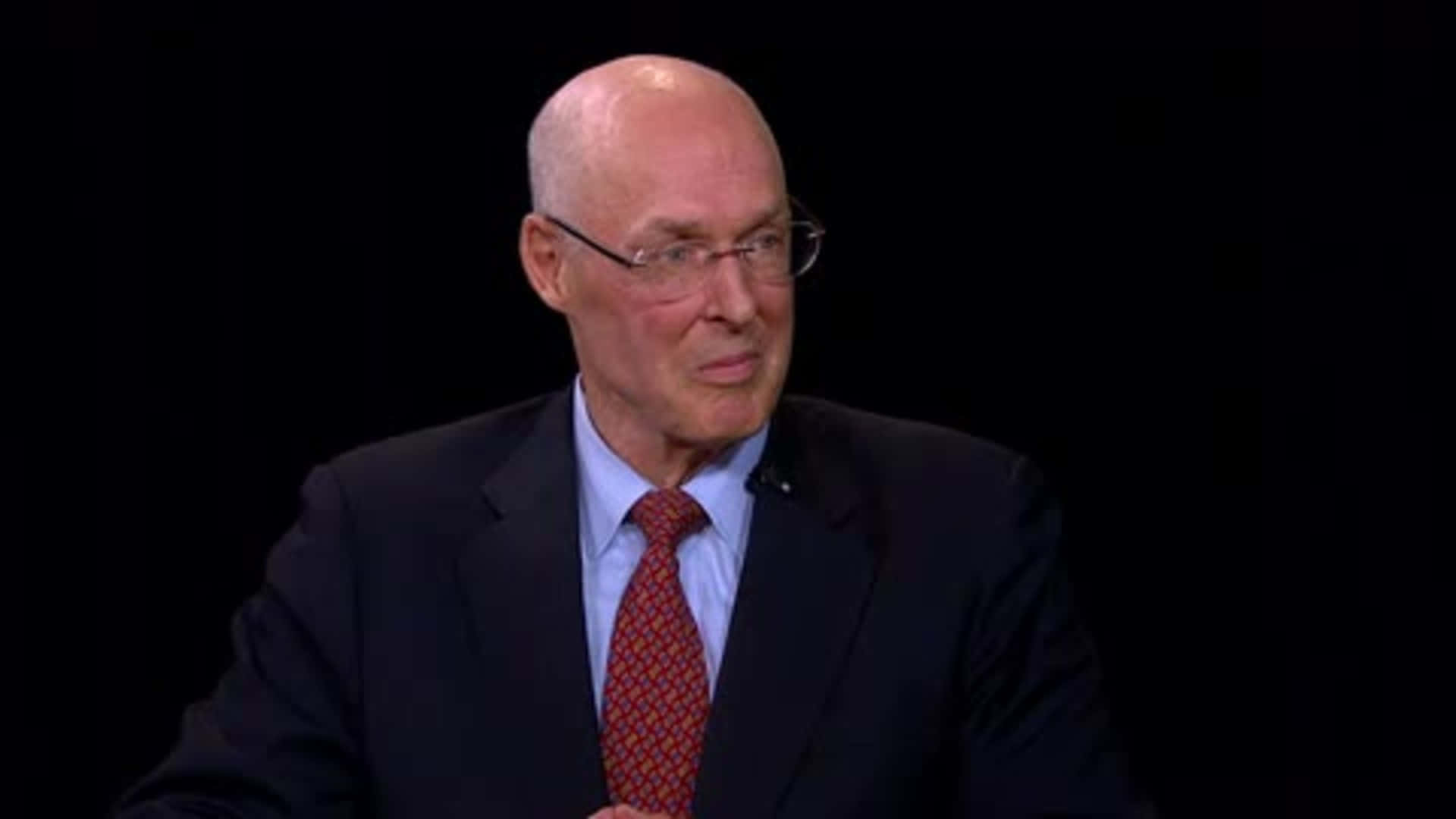 Former US Treasury Secretary Henry Paulson Smiles during an Interview Wallpaper