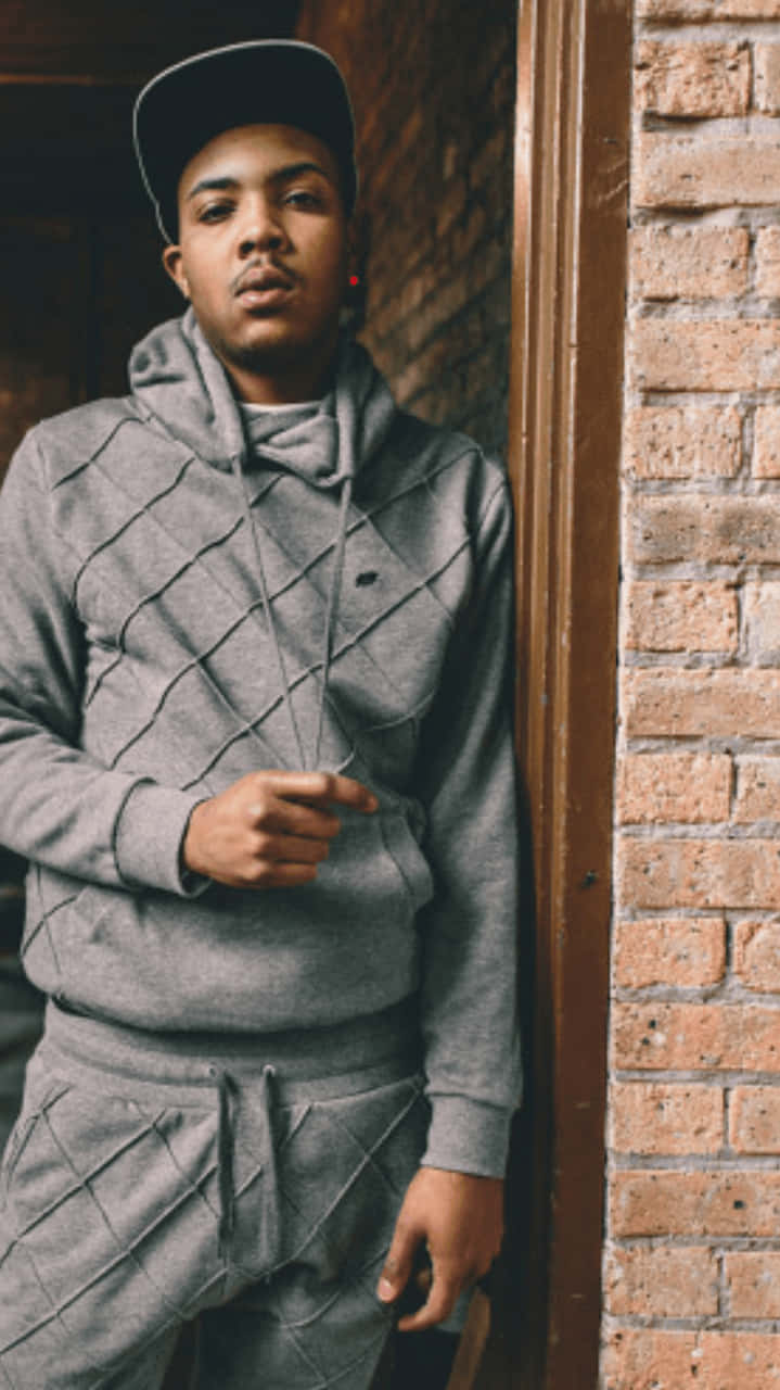 A Young Man In A Grey Hoodie And Tracksuit Wallpaper
