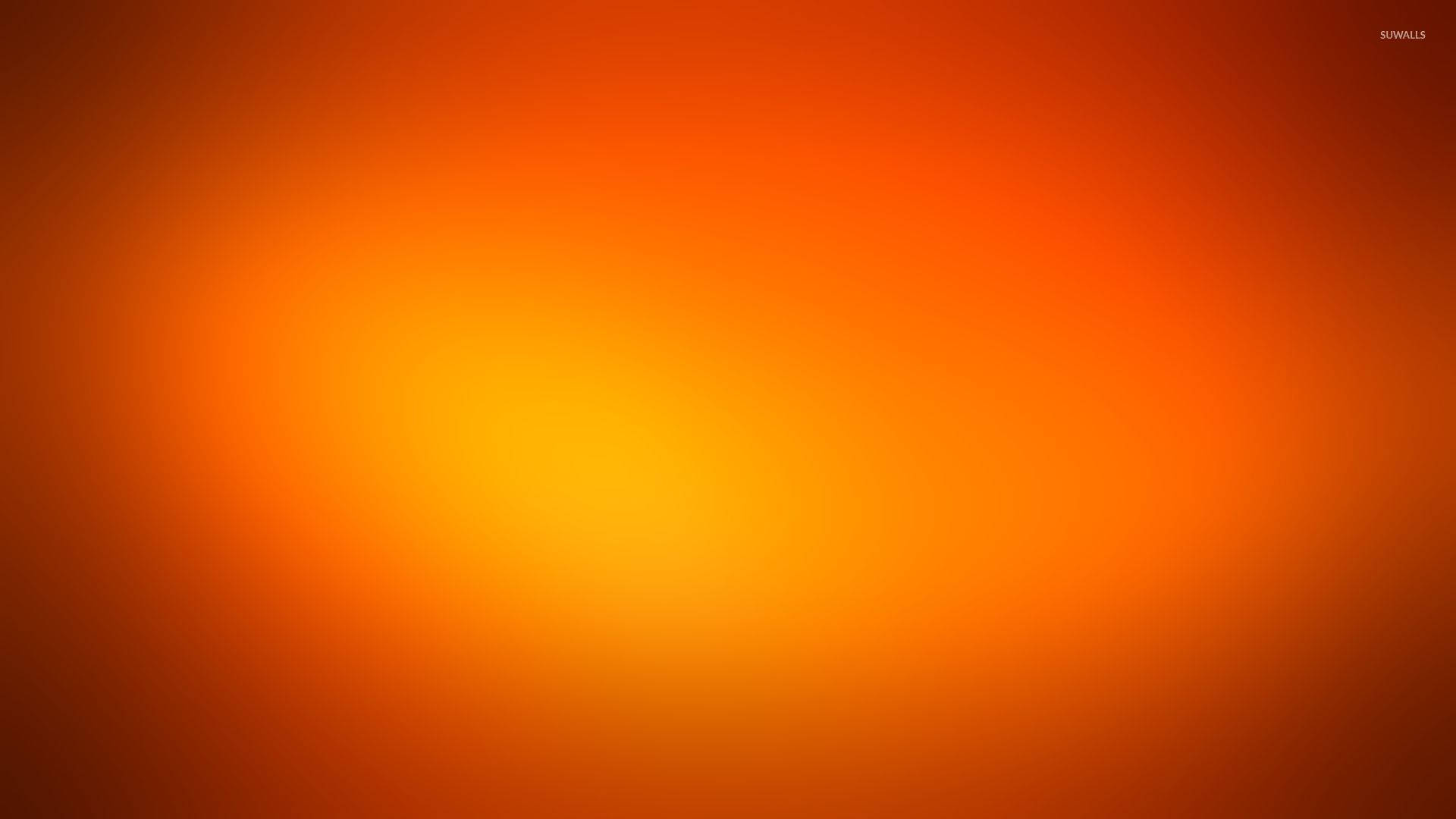 Hot Orange Gradient Wallpaper — A smooth gradient wallpaper transitions from deep orange to bright yellow center with soft glowing warmth.