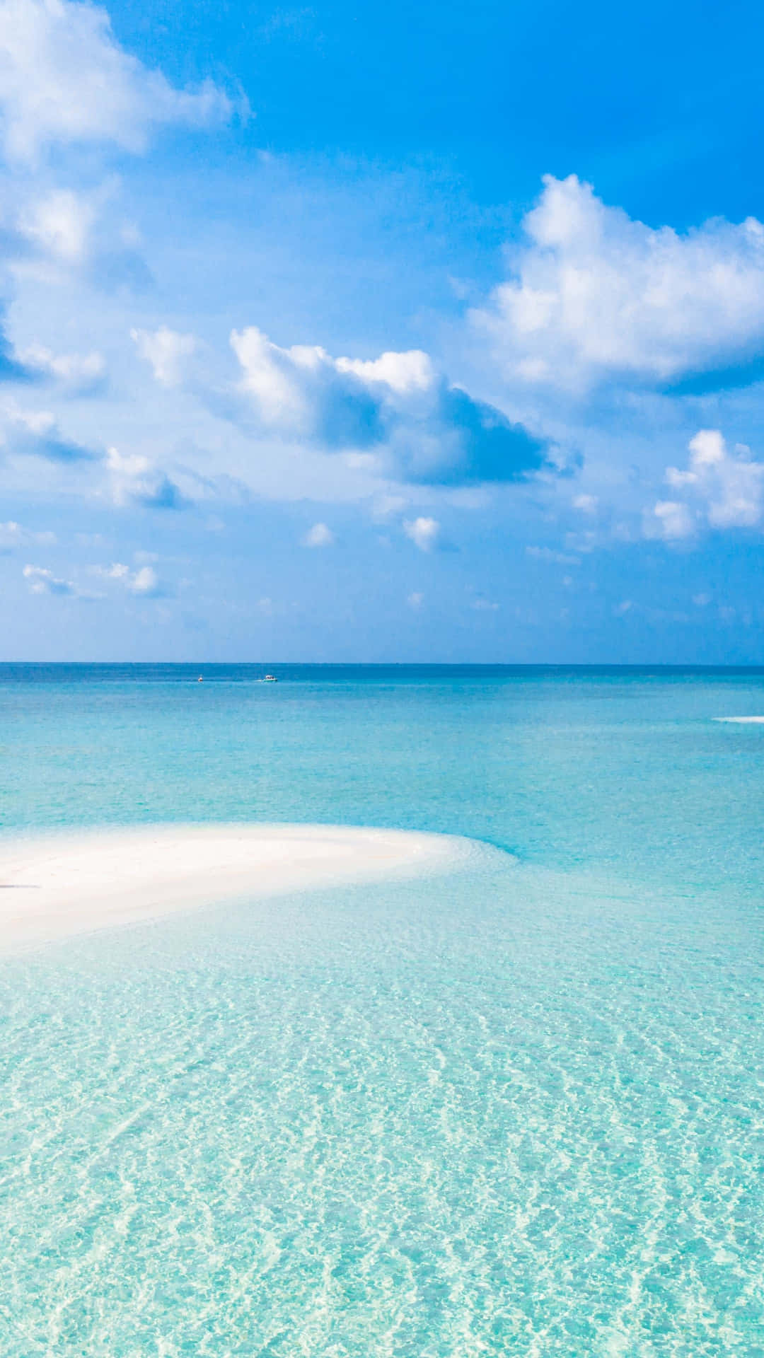 A Beach With A White Sand And Clear Water Wallpaper