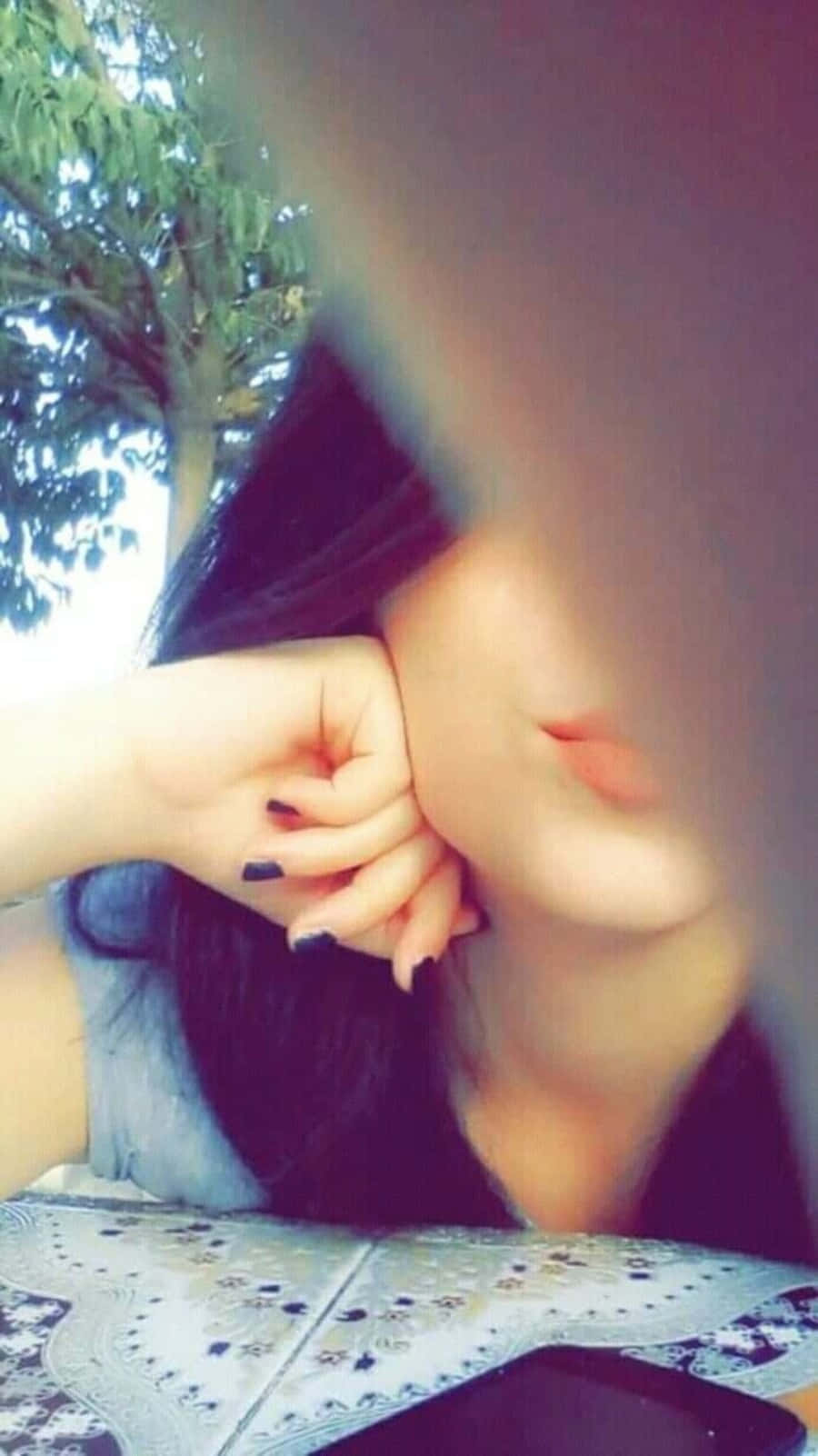 A Girl With Her Hand On Her Face