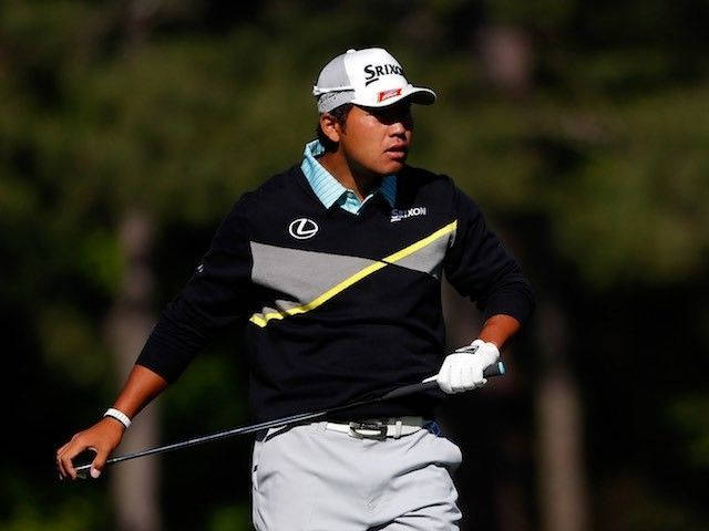 Hideki Matsuyama poised for a powerful swing during a golf tournament. Wallpaper