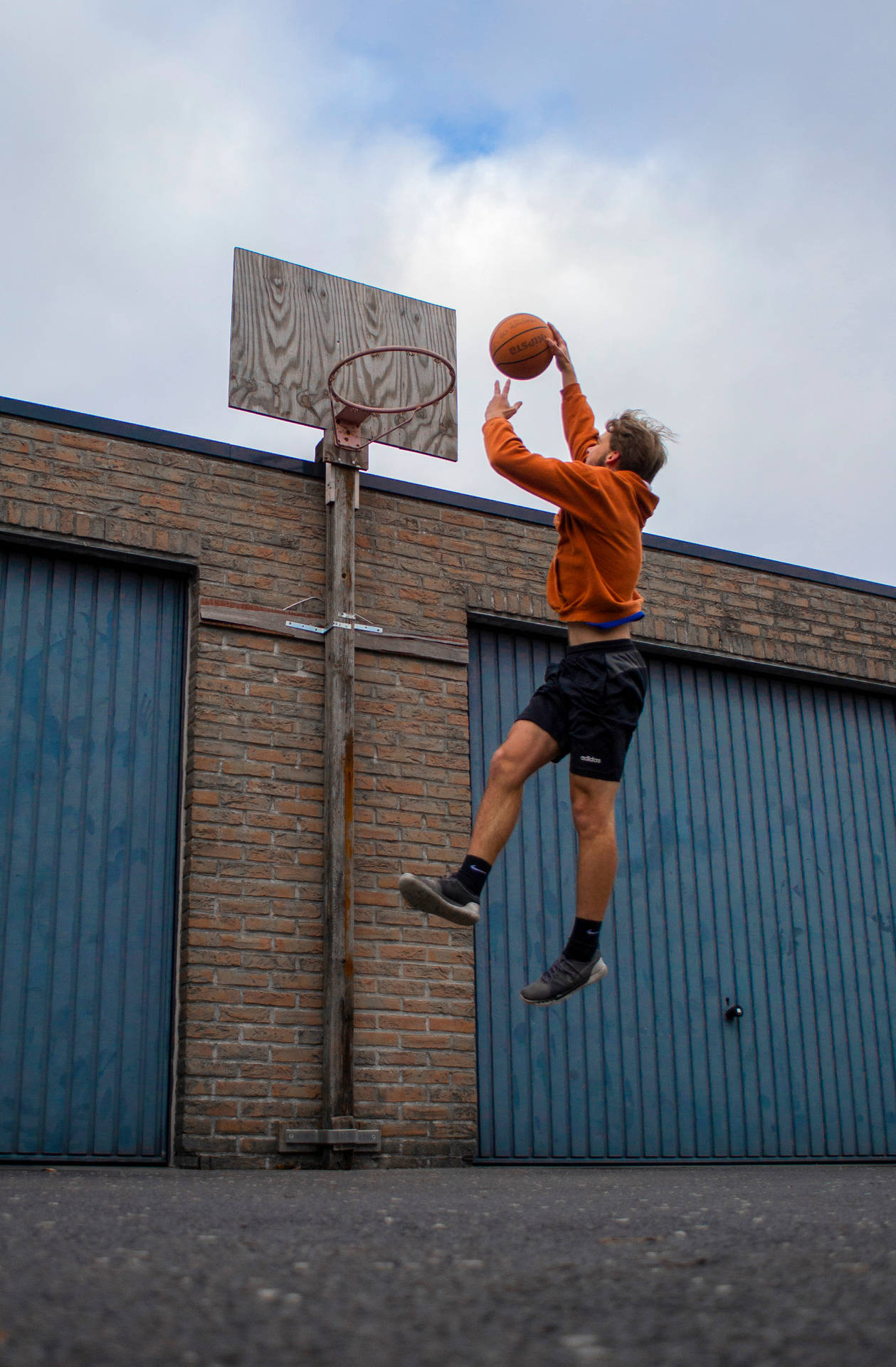 High Flying Slam Dunk In Basketball Game Wallpaper