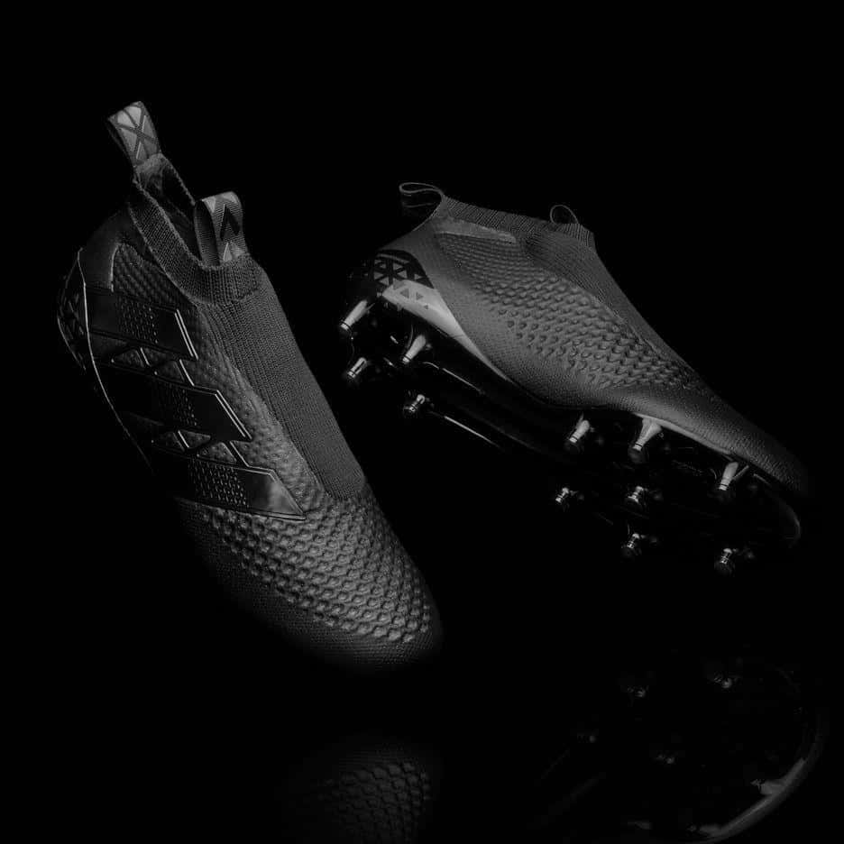 High Performance Soccer Cleats Black Background Wallpaper