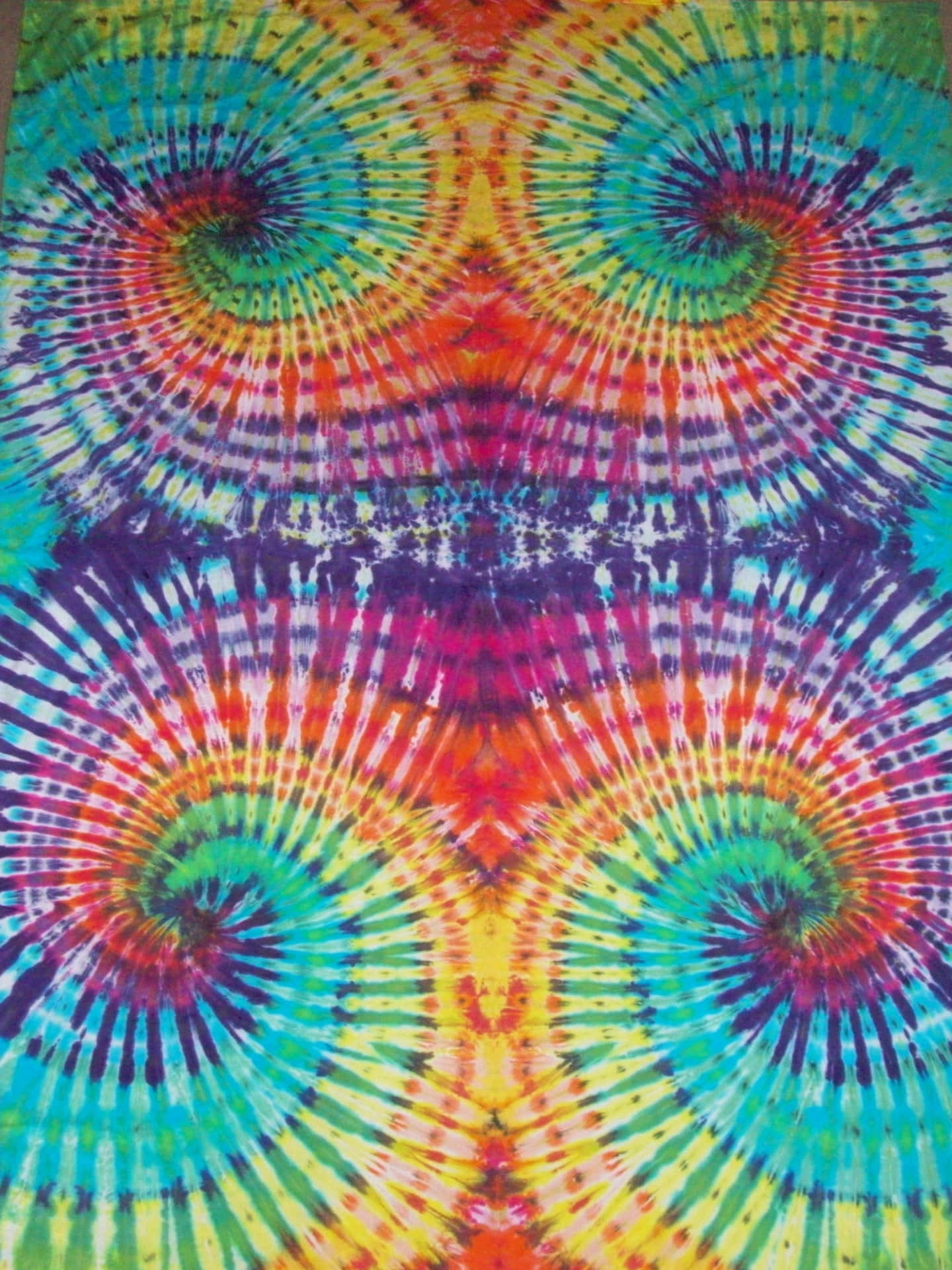 A Colorful Tie Dye Blanket With A Spiral Design