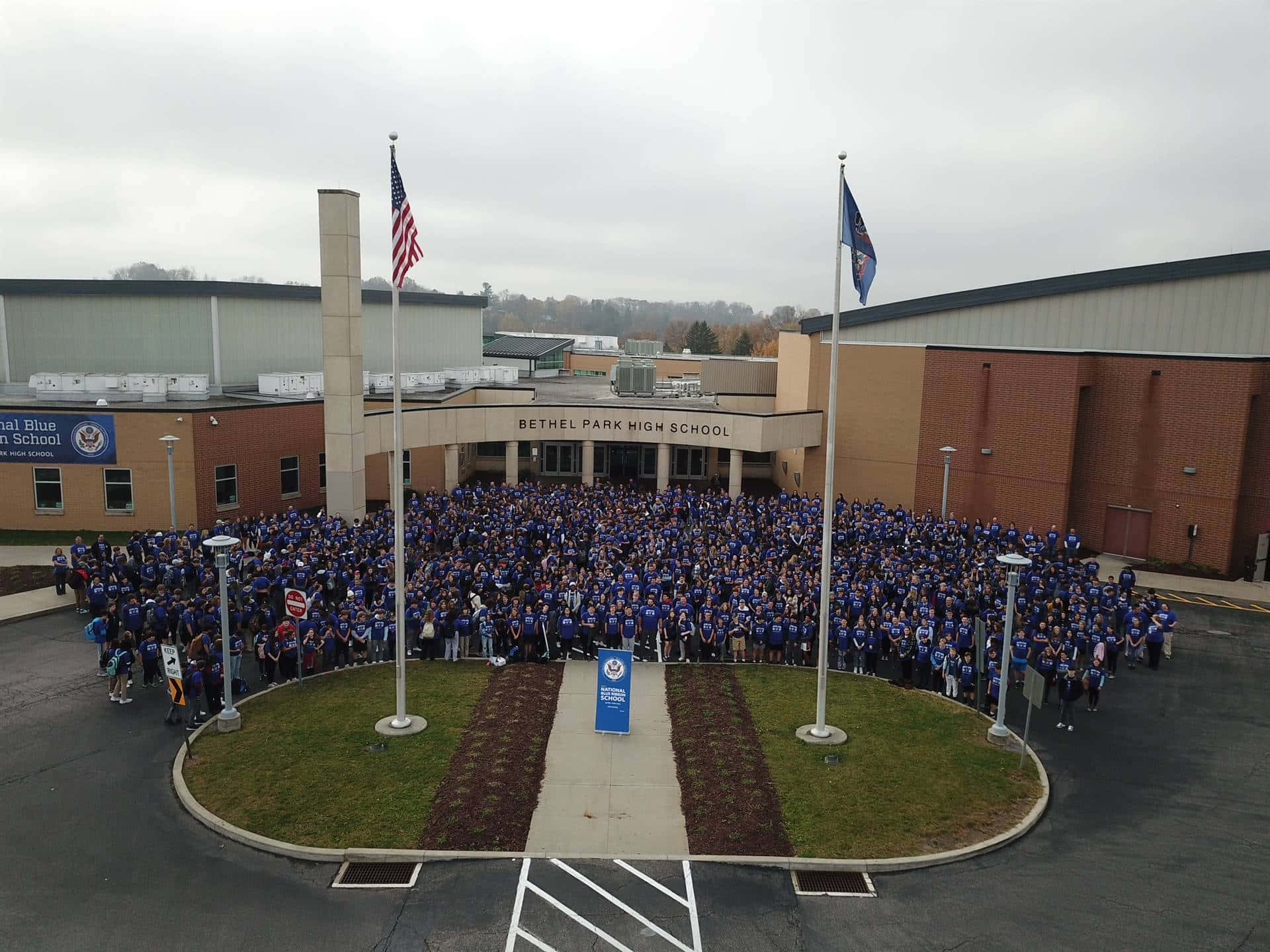 A Large Group Of People In Blue Shirts