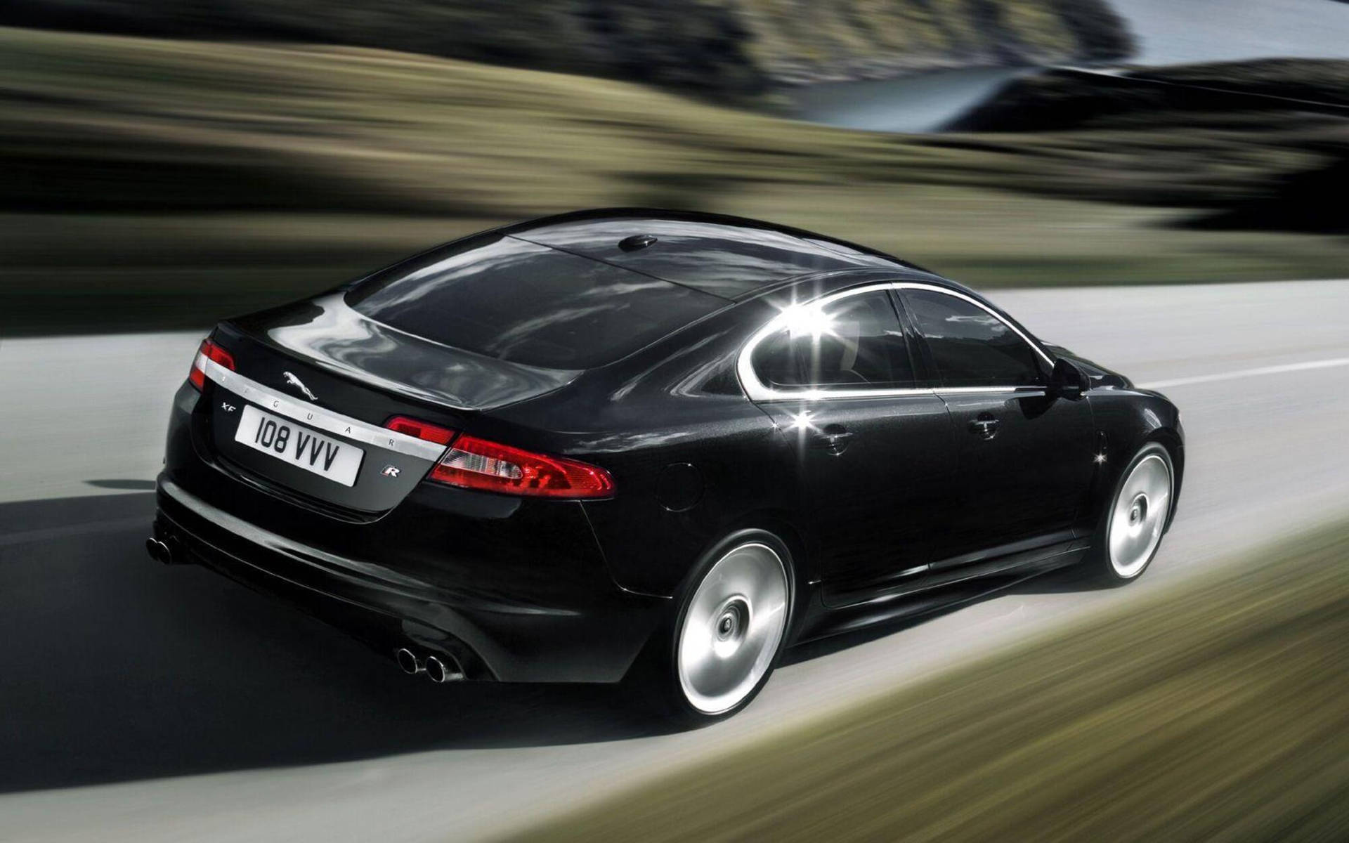 Experience Speed and Luxury with the Black Jaguar Car Wallpaper