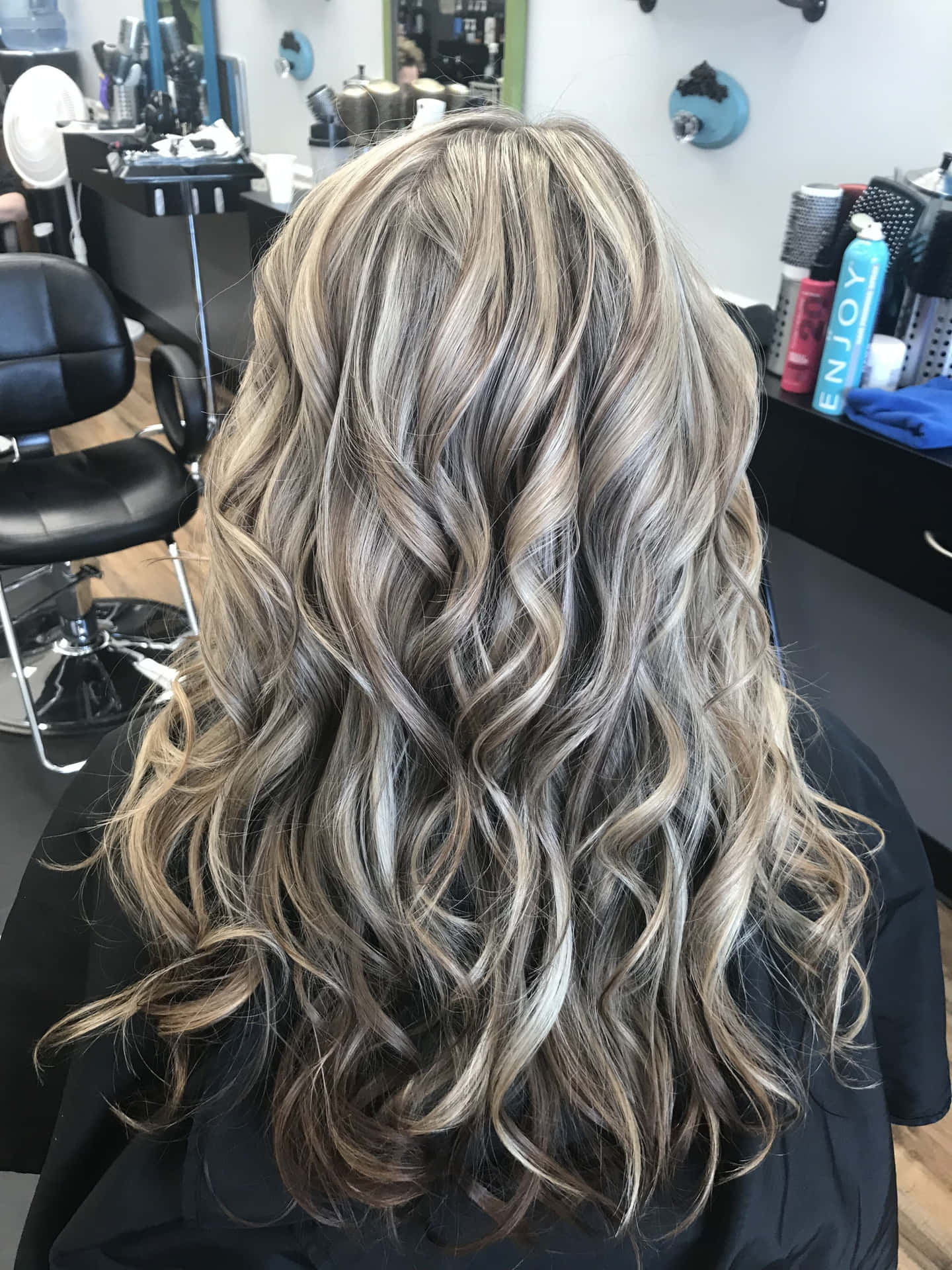 A Woman's Hair In A Salon With Blonde Highlights