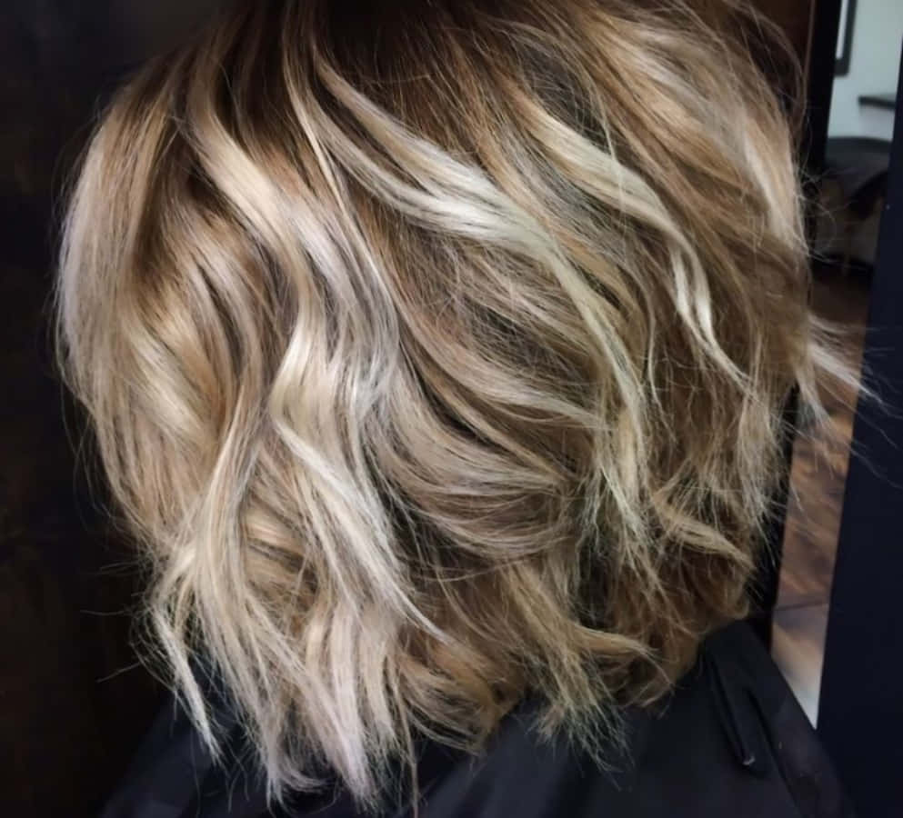 A Woman's Hair With Blonde Highlights And A Wavy Bob
