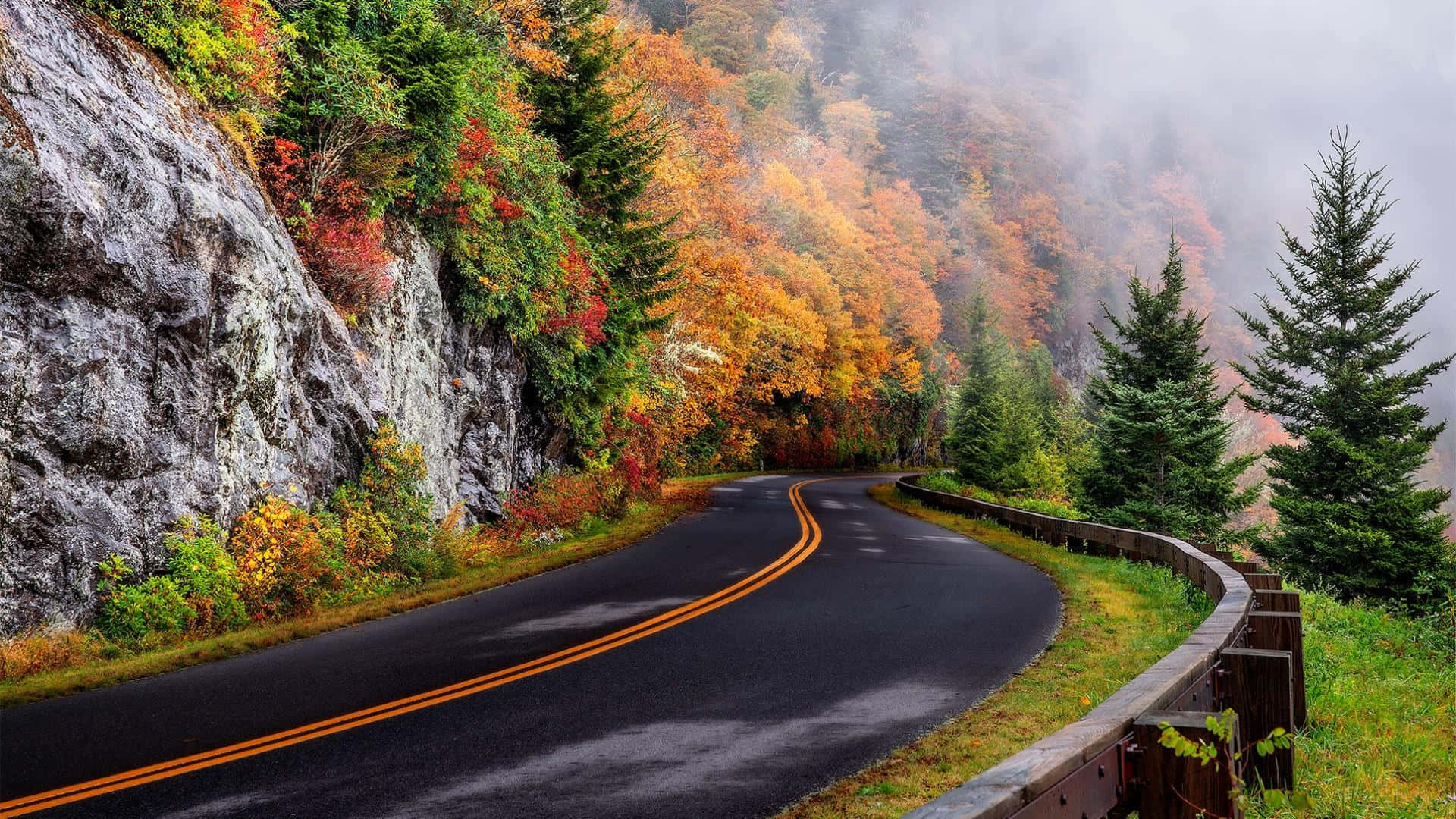 Highway Beside A Mountain Slope Wallpaper