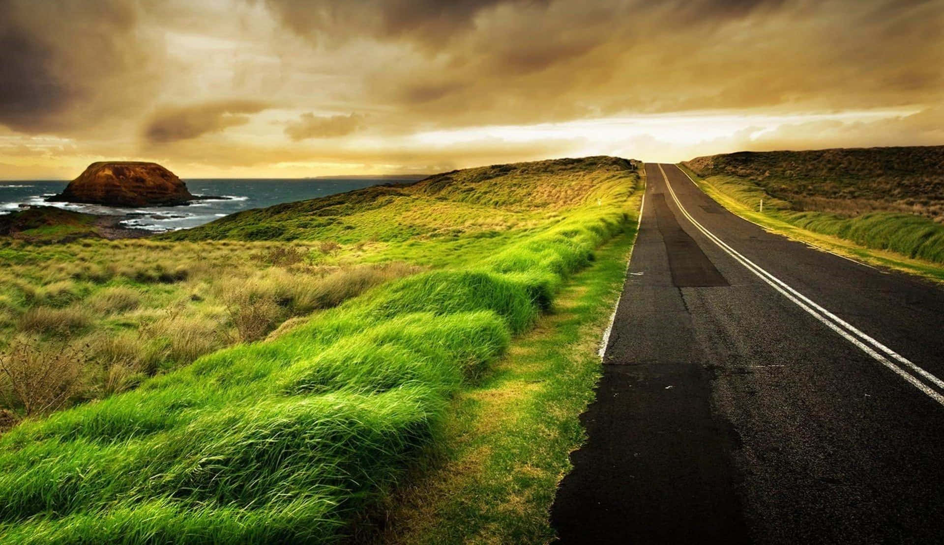 A winding road leads through a mountainous landscape.