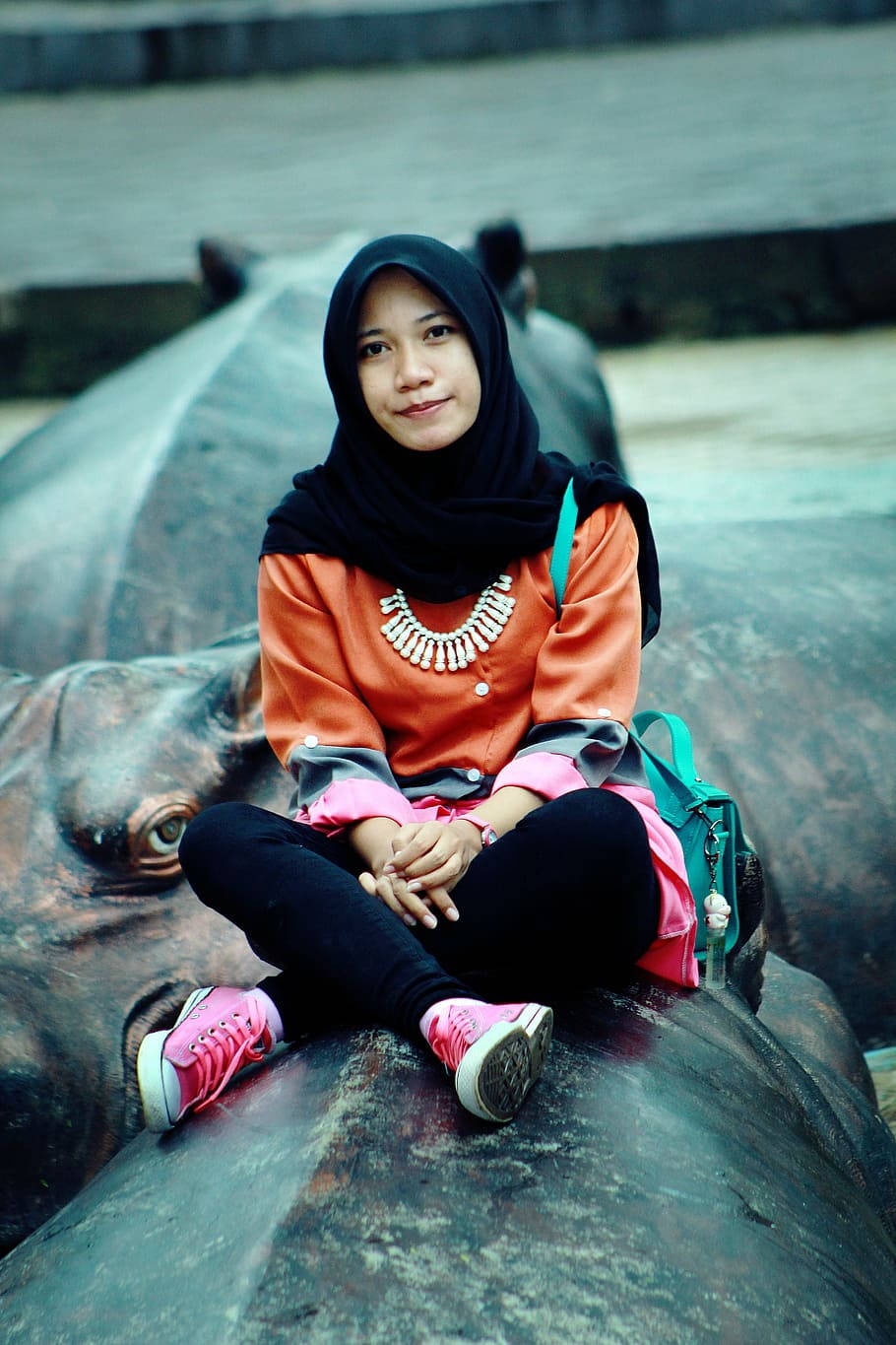 Hijab Girl On Hippopotamus Statue Wallpaper