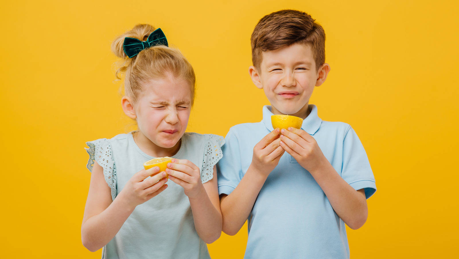 Morsomme børn spiser sur citron Wallpaper