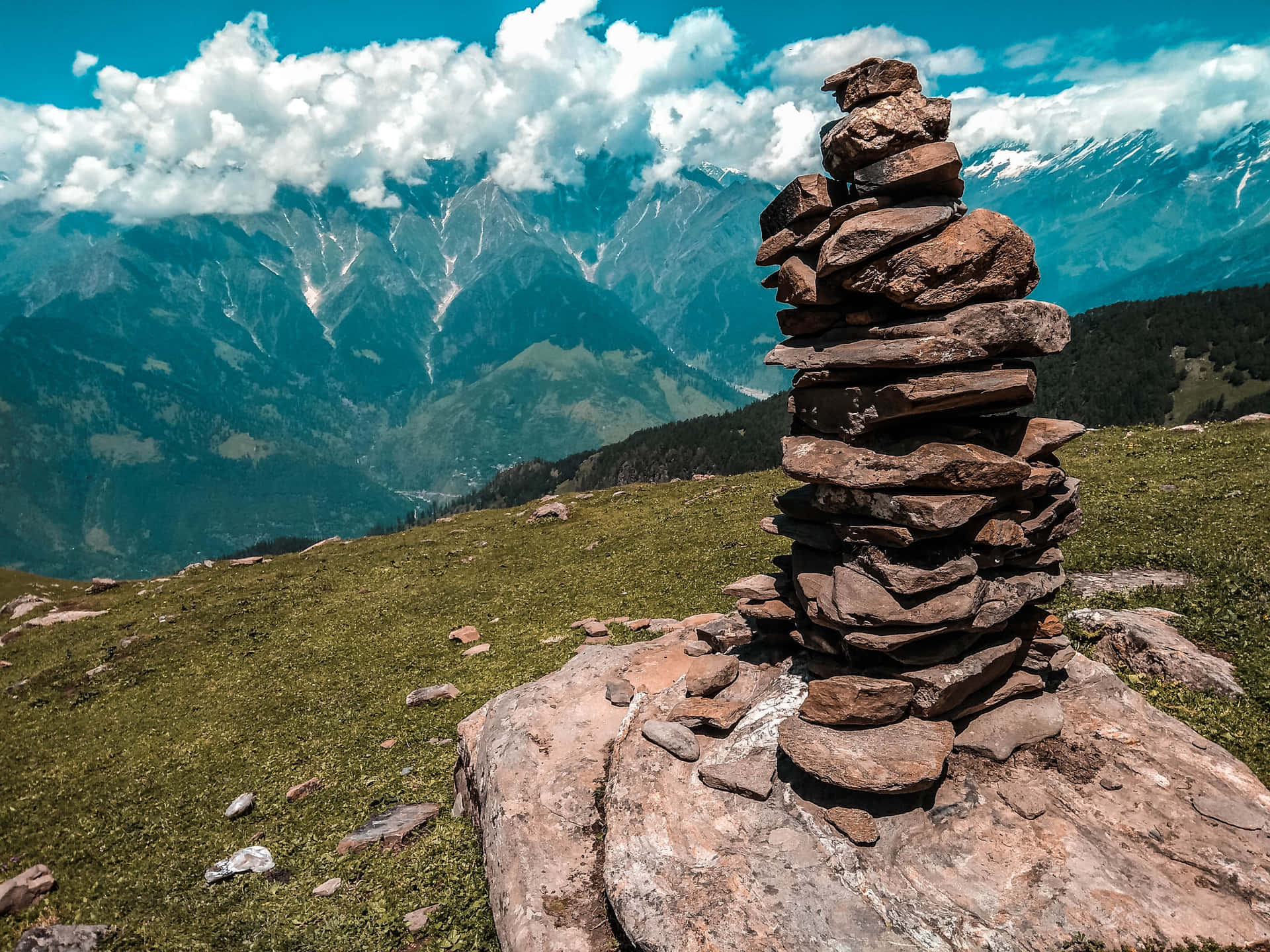 A Stack Of Rocks On Top Of A Hill In The Mountains