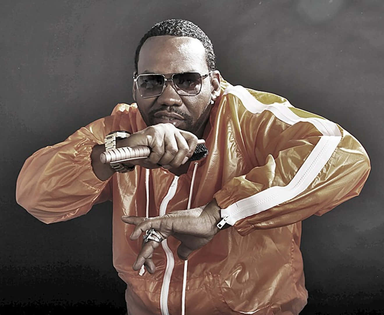 Hip Hop_ Artist_in_ Orange_ Jacket_ Posing Wallpaper