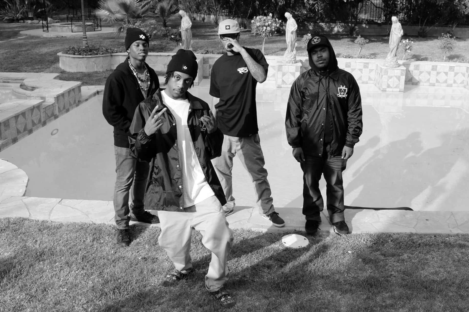 Download Hip Hop_ Group_ Pose_by_ Poolside_ B W Wallpaper | Wallpapers.com